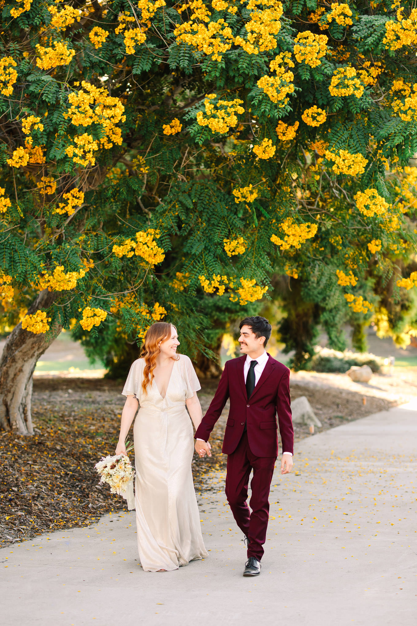 Couple walking among blooming trees | Los Angeles Arboretum Elopement | Colorful and elevated wedding photography for fun-loving couples in Southern California | #LosAngelesElopement #elopement #LAarboretum #LAskyline #elopementphotos   Source: Mary Costa Photography | Los Angeles