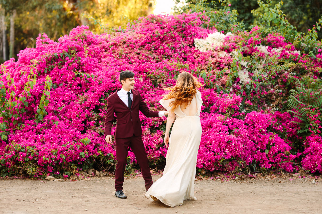 Bride and groom dancing in front of bougainvillea | Los Angeles Arboretum Elopement | Colorful and elevated wedding photography for fun-loving couples in Southern California | #LosAngelesElopement #elopement #LAarboretum #LAskyline #elopementphotos   Source: Mary Costa Photography | Los Angeles 