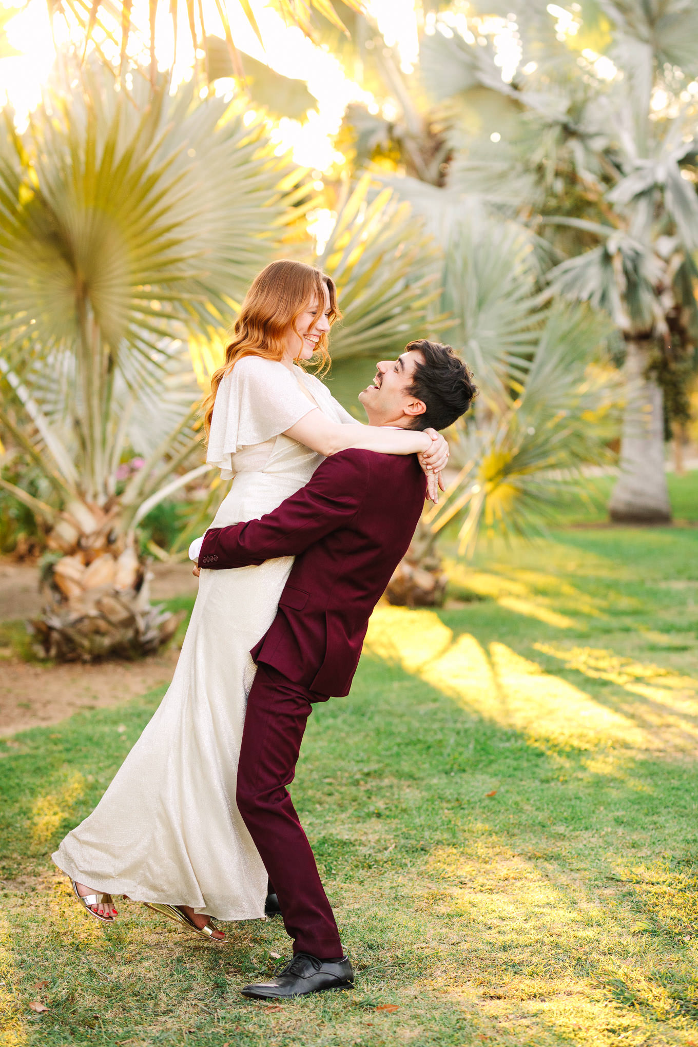 Groom lifting bride in palm garden | Los Angeles Arboretum Elopement | Colorful and elevated wedding photography for fun-loving couples in Southern California | #LosAngelesElopement #elopement #LAarboretum #LAskyline #elopementphotos   Source: Mary Costa Photography | Los Angeles