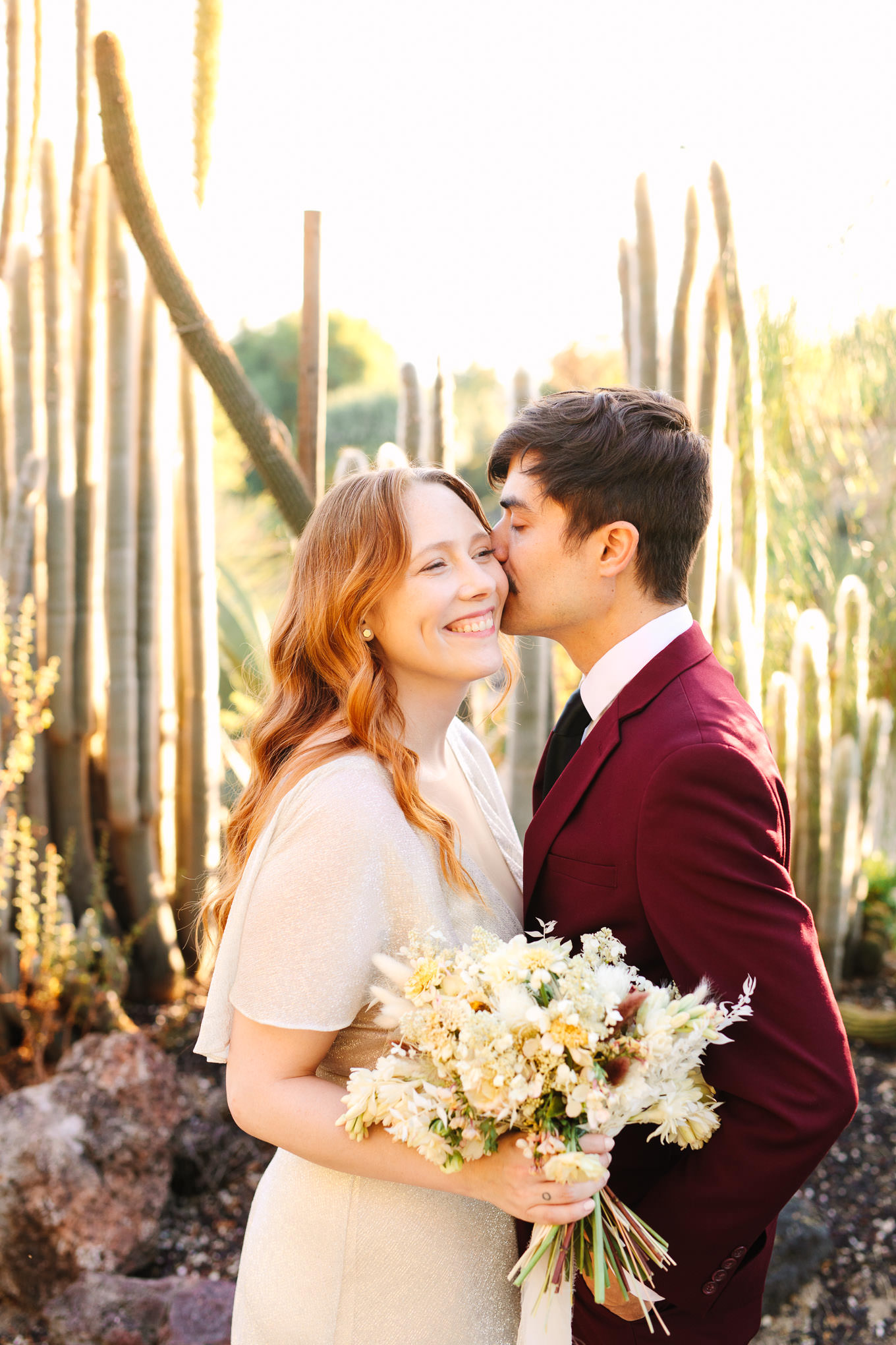 Couple kissing in cacti garden