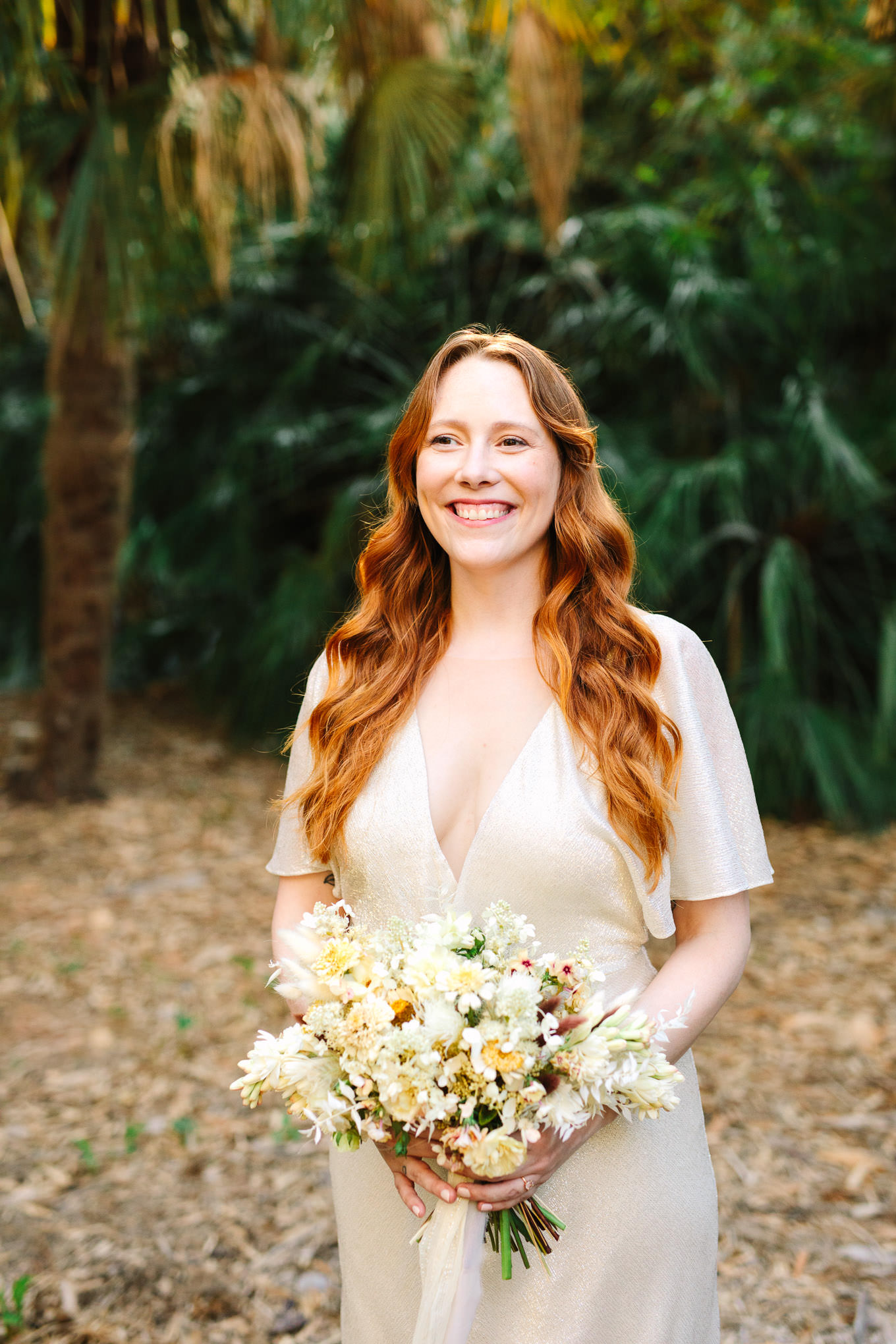 Bride with red wavy hair and boho bouquet laughing | Los Angeles Arboretum Elopement | Colorful and elevated wedding photography for fun-loving couples in Southern California | #LosAngelesElopement #elopement #LAarboretum #LAskyline #elopementphotos   Source: Mary Costa Photography | Los Angeles
