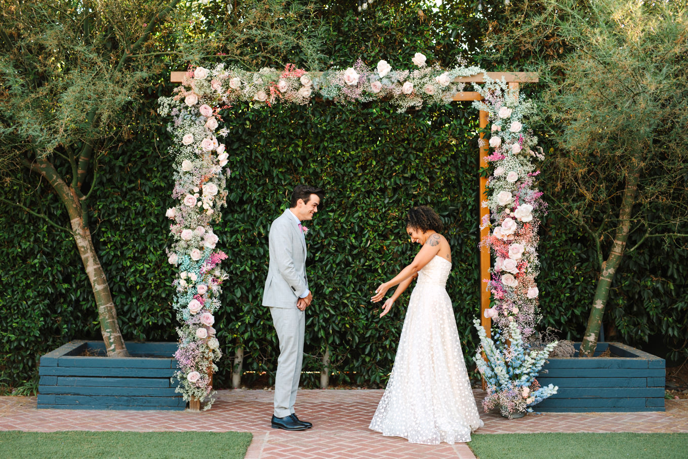 Bride and groom first look | Colorful pop-up micro wedding at The Ruby Street Los Angeles featured on Green Wedding Shoes | Colorful and elevated photography for fun-loving couples in Southern California | #colorfulwedding #popupwedding #weddingphotography #microwedding Source: Mary Costa Photography | Los Angeles