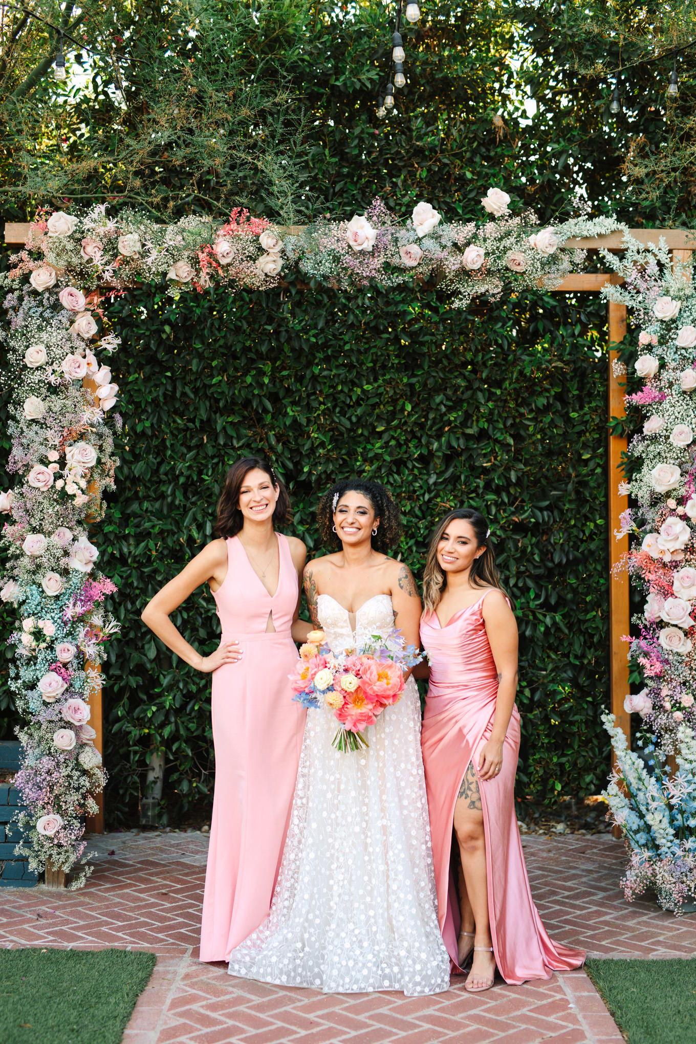 Bride with bridesmaids in light pink | Colorful pop-up micro wedding at The Ruby Street Los Angeles featured on Green Wedding Shoes | Colorful and elevated photography for fun-loving couples in Southern California | #colorfulwedding #popupwedding #weddingphotography #microwedding Source: Mary Costa Photography | Los Angeles