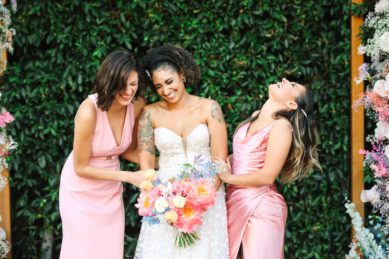 Bridesmaids laughing with bride | Colorful pop-up micro wedding at The Ruby Street Los Angeles featured on Green Wedding Shoes | Colorful and elevated photography for fun-loving couples in Southern California | #colorfulwedding #popupwedding #weddingphotography #microwedding Source: Mary Costa Photography | Los Angeles