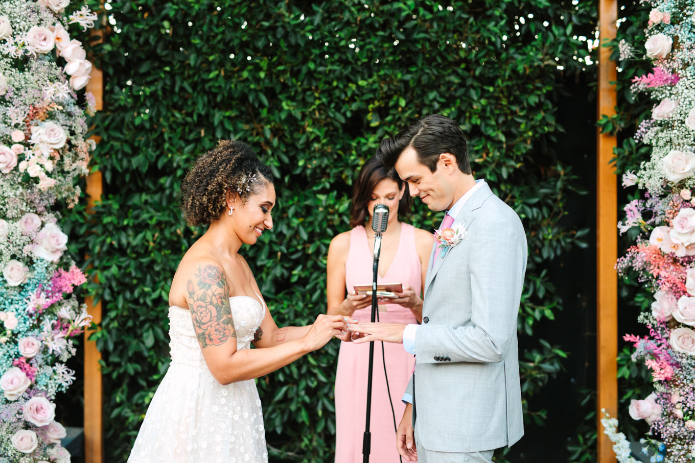 Ring exchange during wedding ceremony | Colorful pop-up micro wedding at The Ruby Street Los Angeles featured on Green Wedding Shoes | Colorful and elevated photography for fun-loving couples in Southern California | #colorfulwedding #popupwedding #weddingphotography #microwedding Source: Mary Costa Photography | Los Angeles