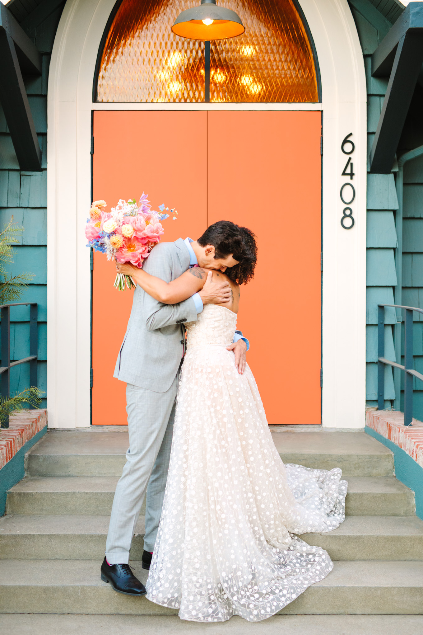 Bride and groom embracing after wedding ceremony | Colorful pop-up micro wedding at The Ruby Street Los Angeles featured on Green Wedding Shoes | Colorful and elevated photography for fun-loving couples in Southern California | #colorfulwedding #popupwedding #weddingphotography #microwedding Source: Mary Costa Photography | Los Angeles