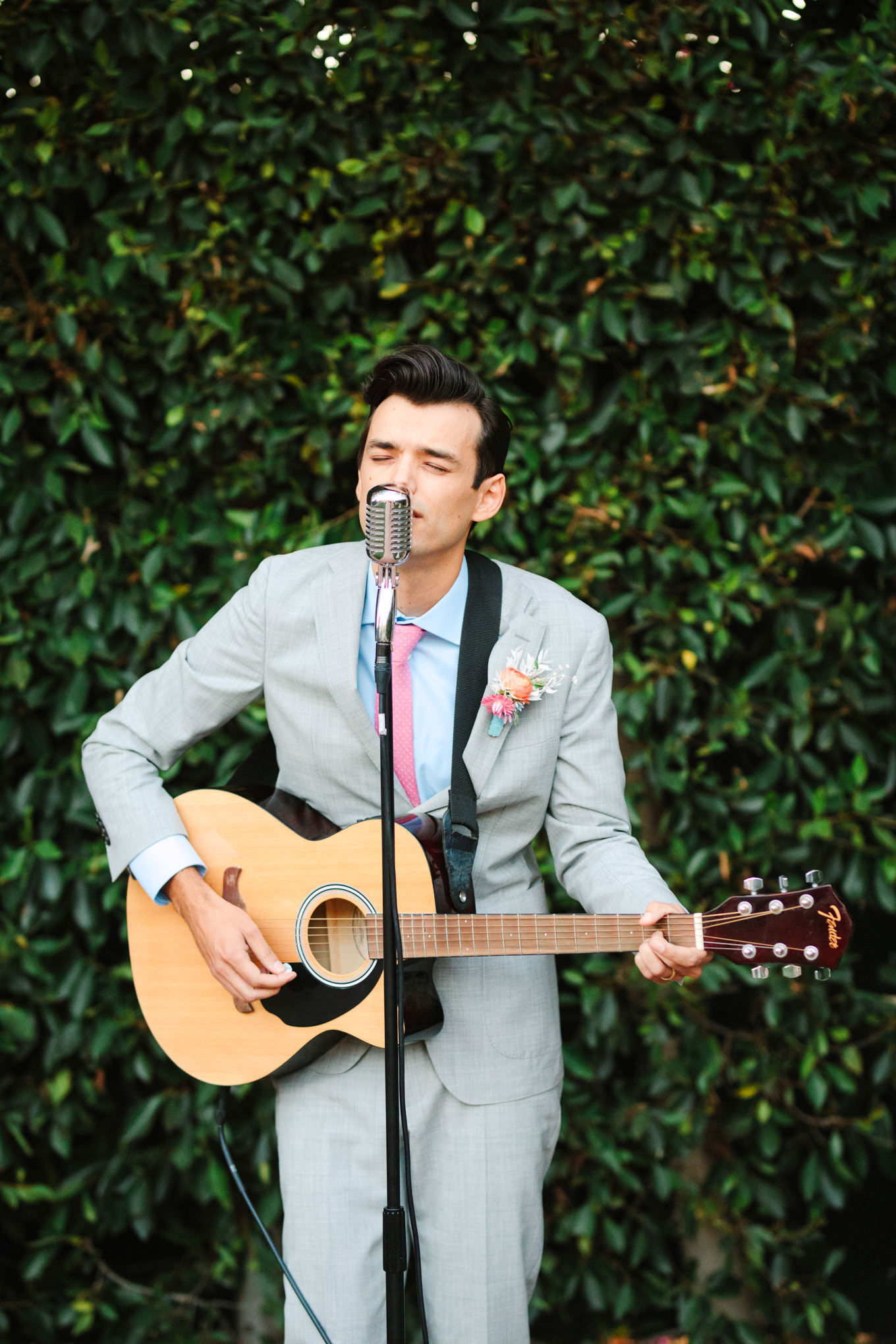 Groom singing to the bride | Colorful pop-up micro wedding at The Ruby Street Los Angeles featured on Green Wedding Shoes | Colorful and elevated photography for fun-loving couples in Southern California | #colorfulwedding #popupwedding #weddingphotography #microwedding Source: Mary Costa Photography | Los Angeles