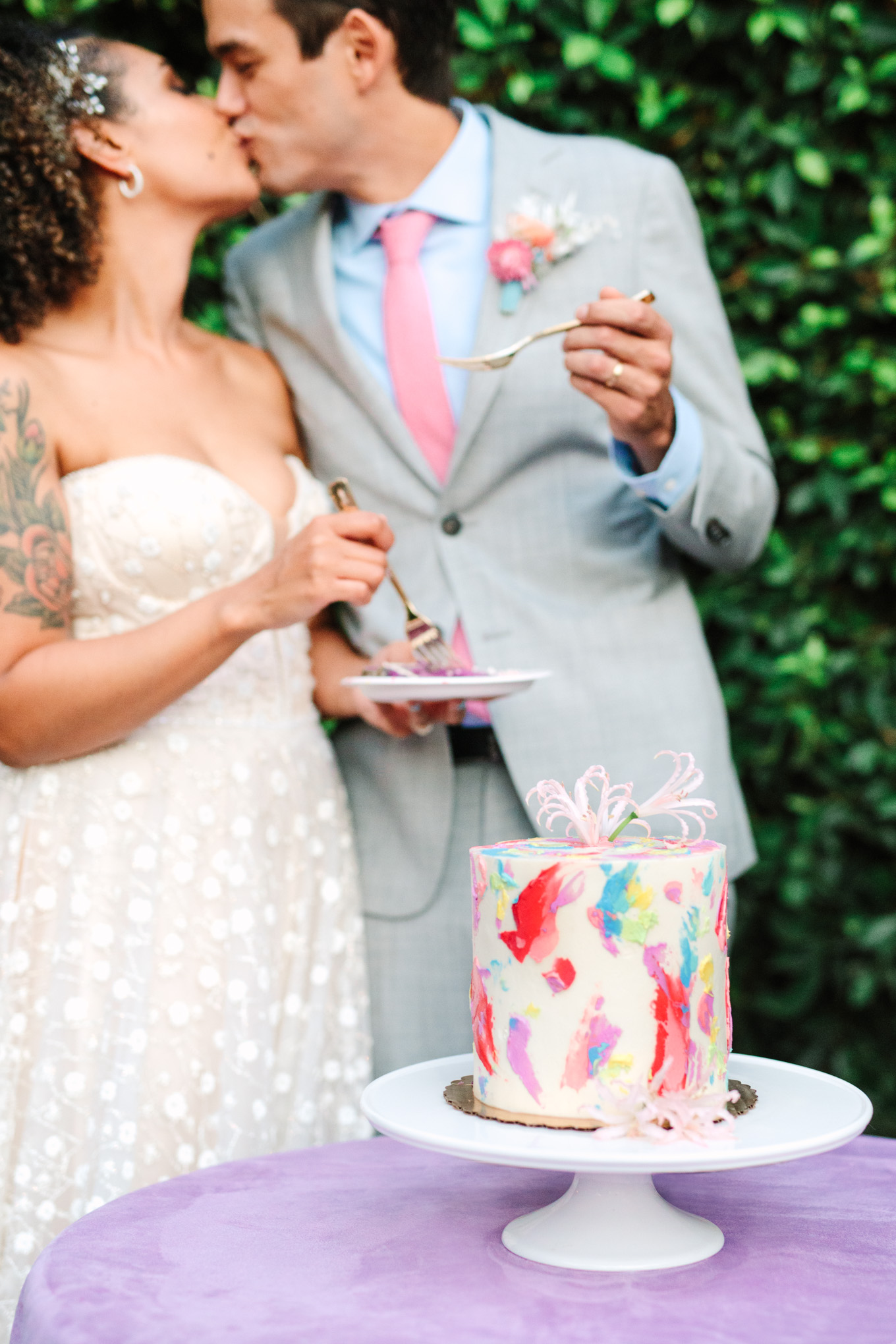 Bride and groom cutting colorful watercolor taro cake by Flouring LA | Colorful pop-up micro wedding at The Ruby Street Los Angeles featured on Green Wedding Shoes | Colorful and elevated photography for fun-loving couples in Southern California | #colorfulwedding #popupwedding #weddingphotography #microwedding Source: Mary Costa Photography | Los Angeles