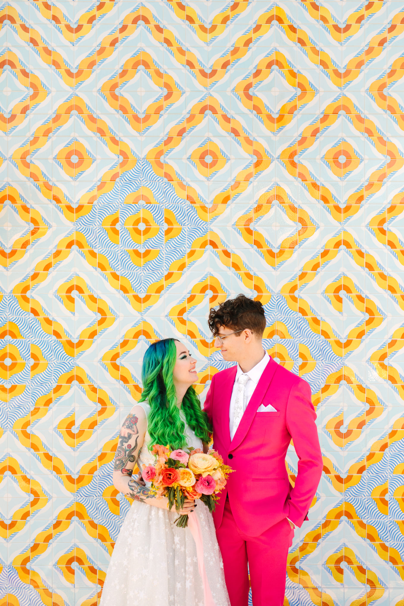 Green hair bride and groom in hot pink suit in front of Bavel DTLA | Colorful wedding at The Unique Space Los Angeles published in The Knot Magazine | Fresh and colorful photography for fun-loving couples in Southern California | #colorfulwedding #losangeleswedding #weddingphotography #uniquespace Source: Mary Costa Photography | Los Angeles