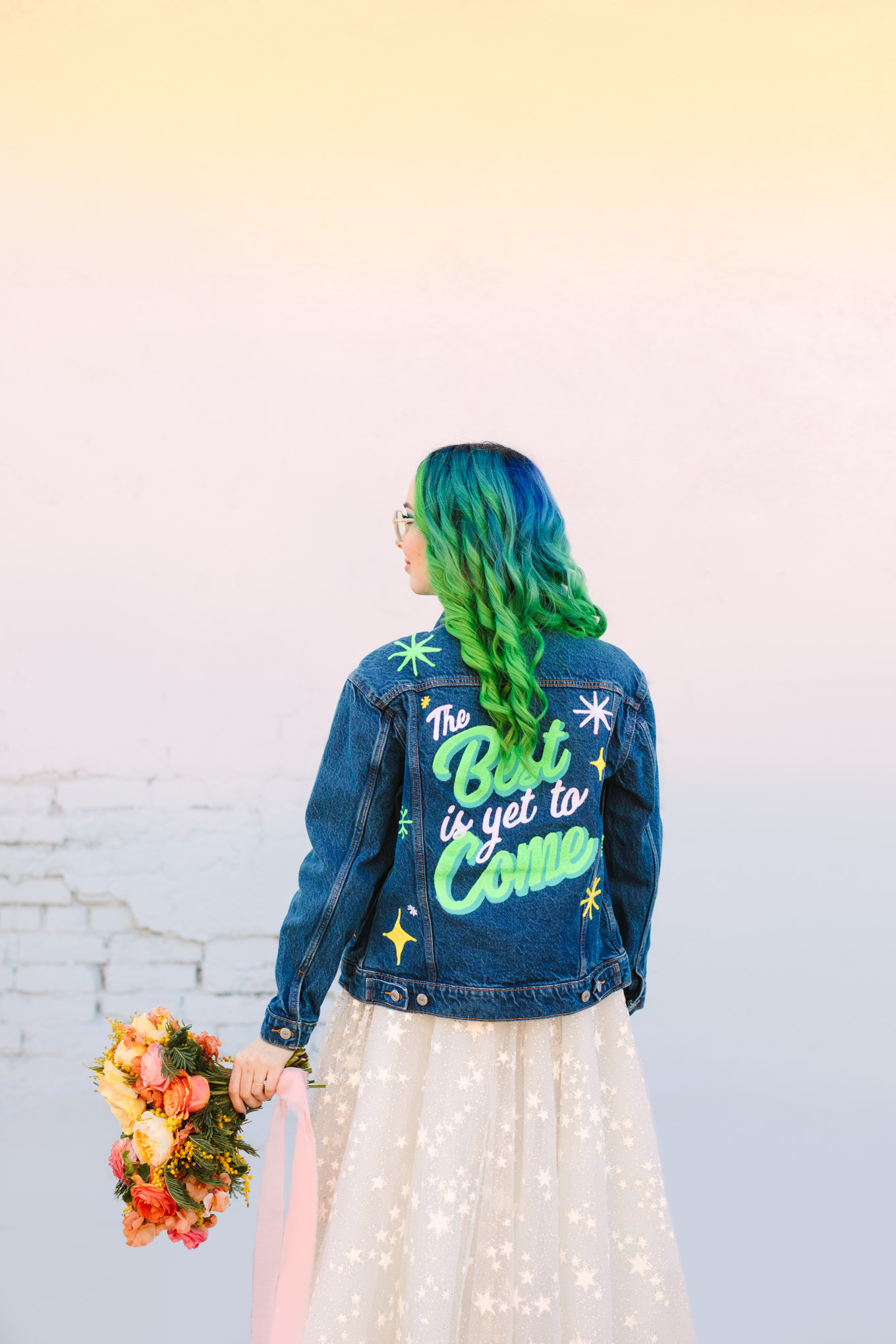 Bride with green ombre hair in custom denim jacket | Colorful wedding at The Unique Space Los Angeles published in The Knot Magazine | Fresh and colorful photography for fun-loving couples in Southern California | #colorfulwedding #losangeleswedding #weddingphotography #uniquespace Source: Mary Costa Photography | Los Angeles