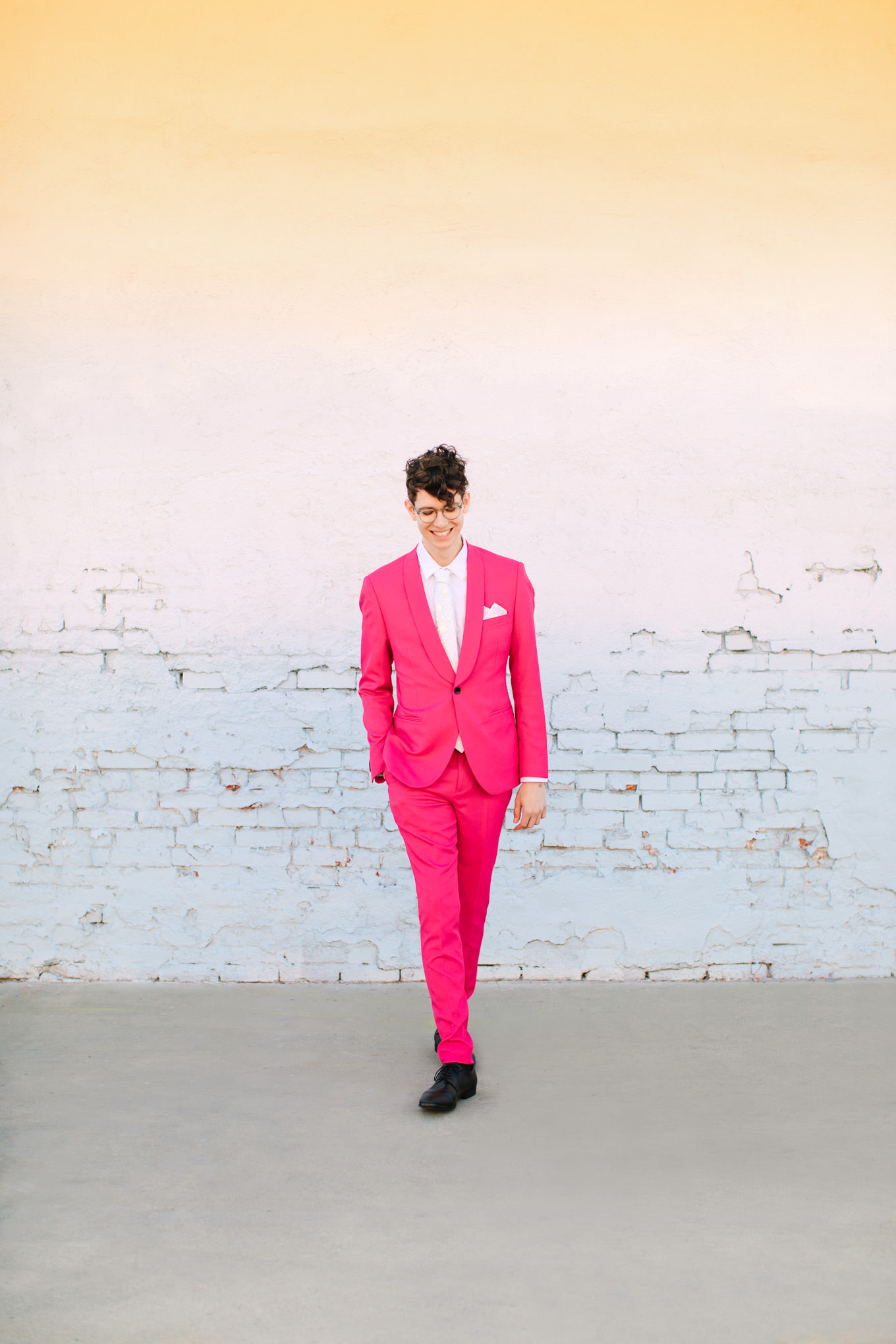 Groom walking in hot pink suit | Colorful wedding at The Unique Space Los Angeles published in The Knot Magazine | Fresh and colorful photography for fun-loving couples in Southern California | #colorfulwedding #losangeleswedding #weddingphotography #uniquespace Source: Mary Costa Photography | Los Angeles
