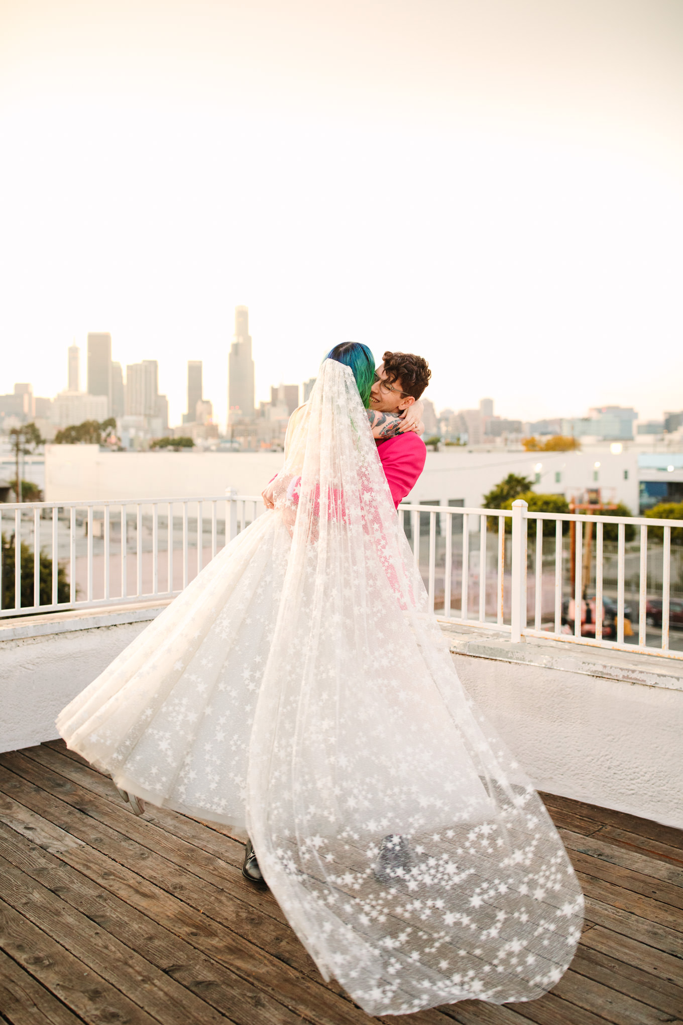 Portraits on rooftop with green hair bride in star gown and groom in hot pink suit | Colorful wedding at The Unique Space Los Angeles published in The Knot Magazine | Fresh and colorful photography for fun-loving couples in Southern California | #colorfulwedding #losangeleswedding #weddingphotography #uniquespace Source: Mary Costa Photography | Los Angeles