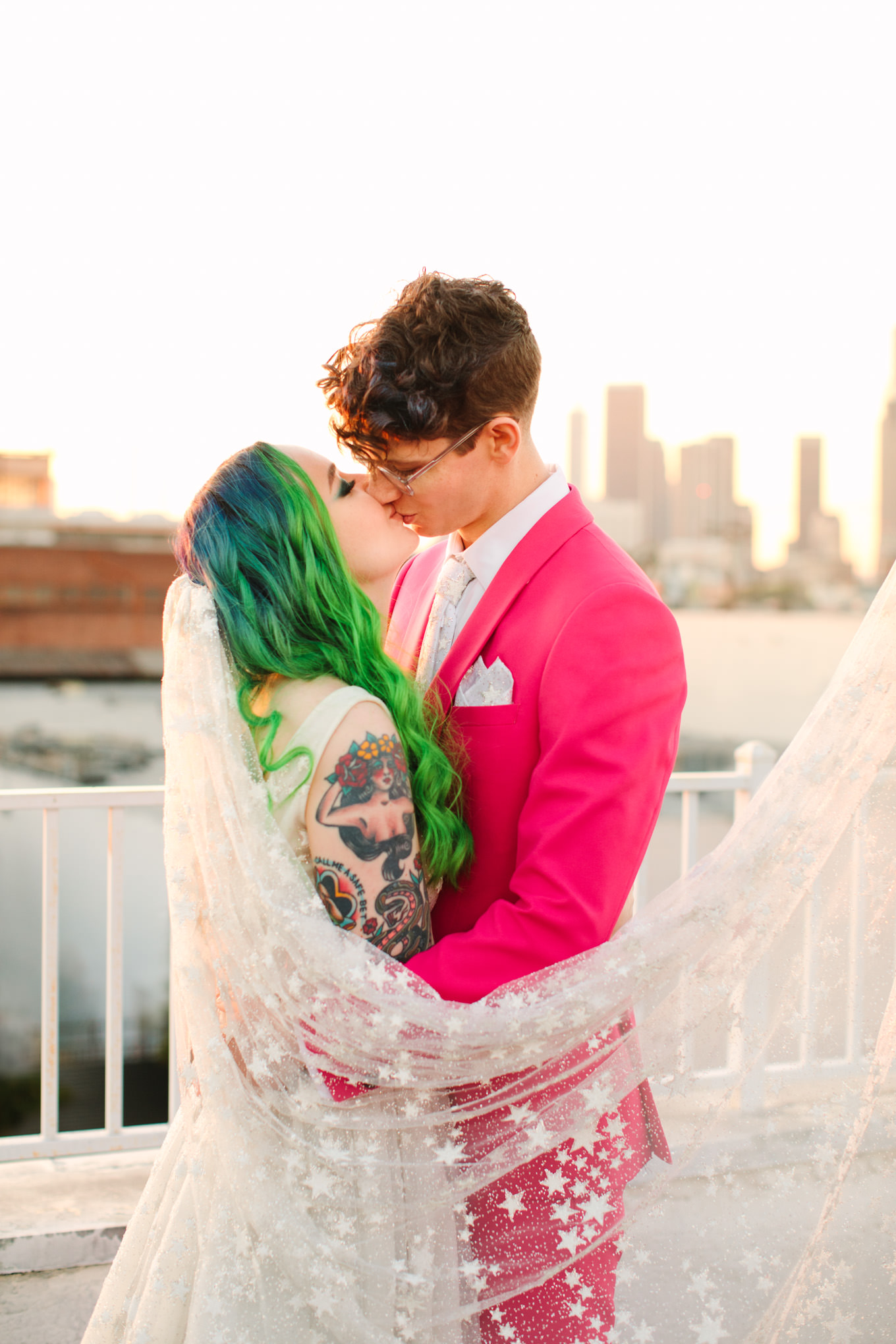 Portraits on rooftop with green hair bride in star gown and groom in hot pink suit | Colorful wedding at The Unique Space Los Angeles published in The Knot Magazine | Fresh and colorful photography for fun-loving couples in Southern California | #colorfulwedding #losangeleswedding #weddingphotography #uniquespace Source: Mary Costa Photography | Los Angeles