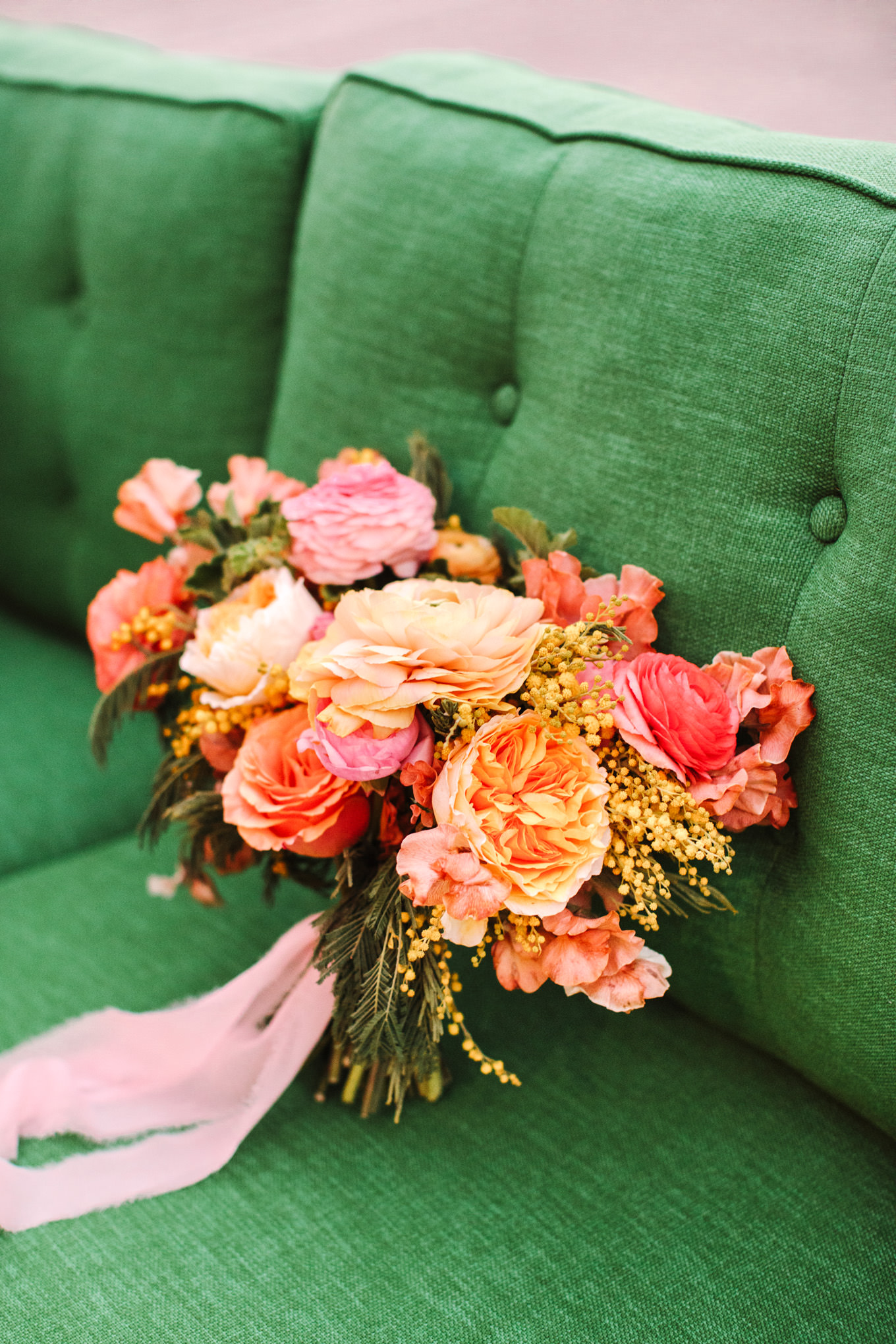 Colorful bouquet on green couch | Colorful wedding at The Unique Space Los Angeles published in The Knot Magazine | Fresh and colorful photography for fun-loving couples in Southern California | #colorfulwedding #losangeleswedding #weddingphotography #uniquespace Source: Mary Costa Photography | Los Angeles