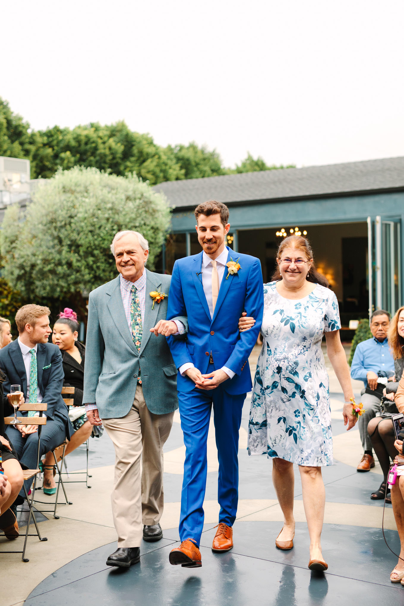 Groom entering ceremony with parents | TV inspired wedding at The Fig House Los Angeles | Published on The Knot | Fresh and colorful photography for fun-loving couples in Southern California | #losangeleswedding #TVwedding #colorfulwedding #theknot   Source: Mary Costa Photography | Los Angeles wedding photographer