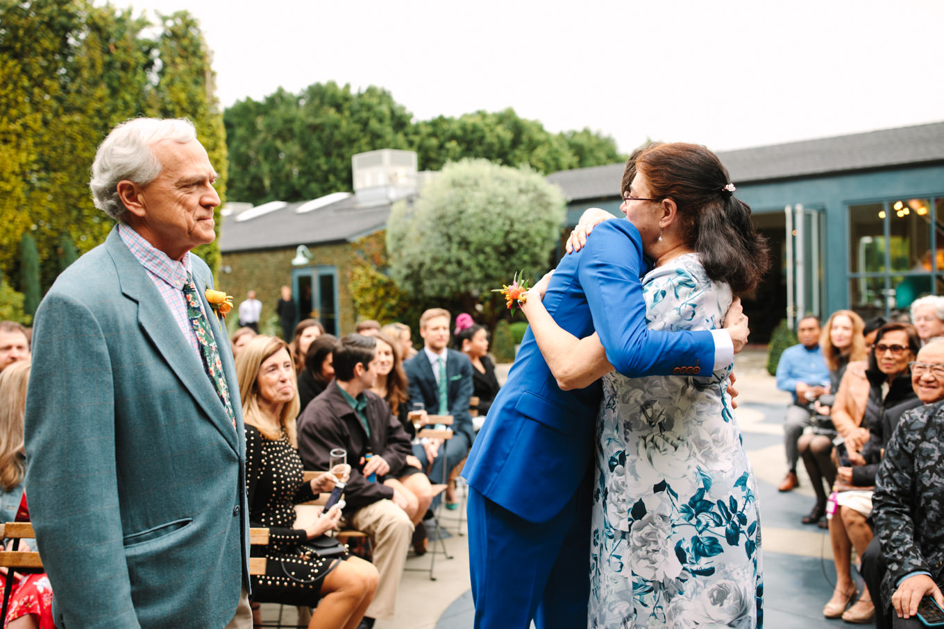 Groom hugging mom at wedding ceremony | TV inspired wedding at The Fig House Los Angeles | Published on The Knot | Fresh and colorful photography for fun-loving couples in Southern California | #losangeleswedding #TVwedding #colorfulwedding #theknot   Source: Mary Costa Photography | Los Angeles wedding photographer