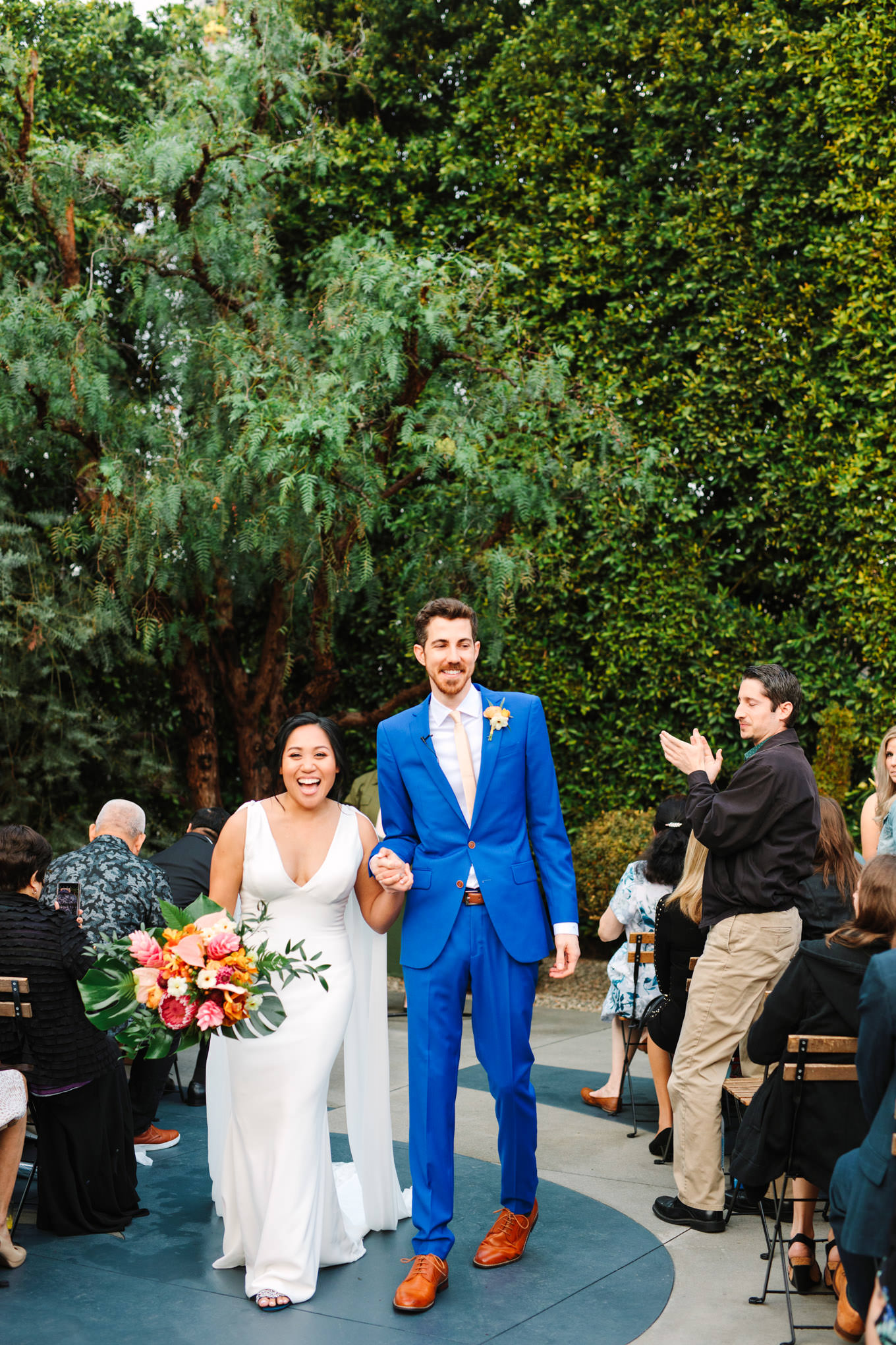 Bride and groom exiting wedding ceremony | TV inspired wedding at The Fig House Los Angeles | Published on The Knot | Fresh and colorful photography for fun-loving couples in Southern California | #losangeleswedding #TVwedding #colorfulwedding #theknot   Source: Mary Costa Photography | Los Angeles wedding photographer