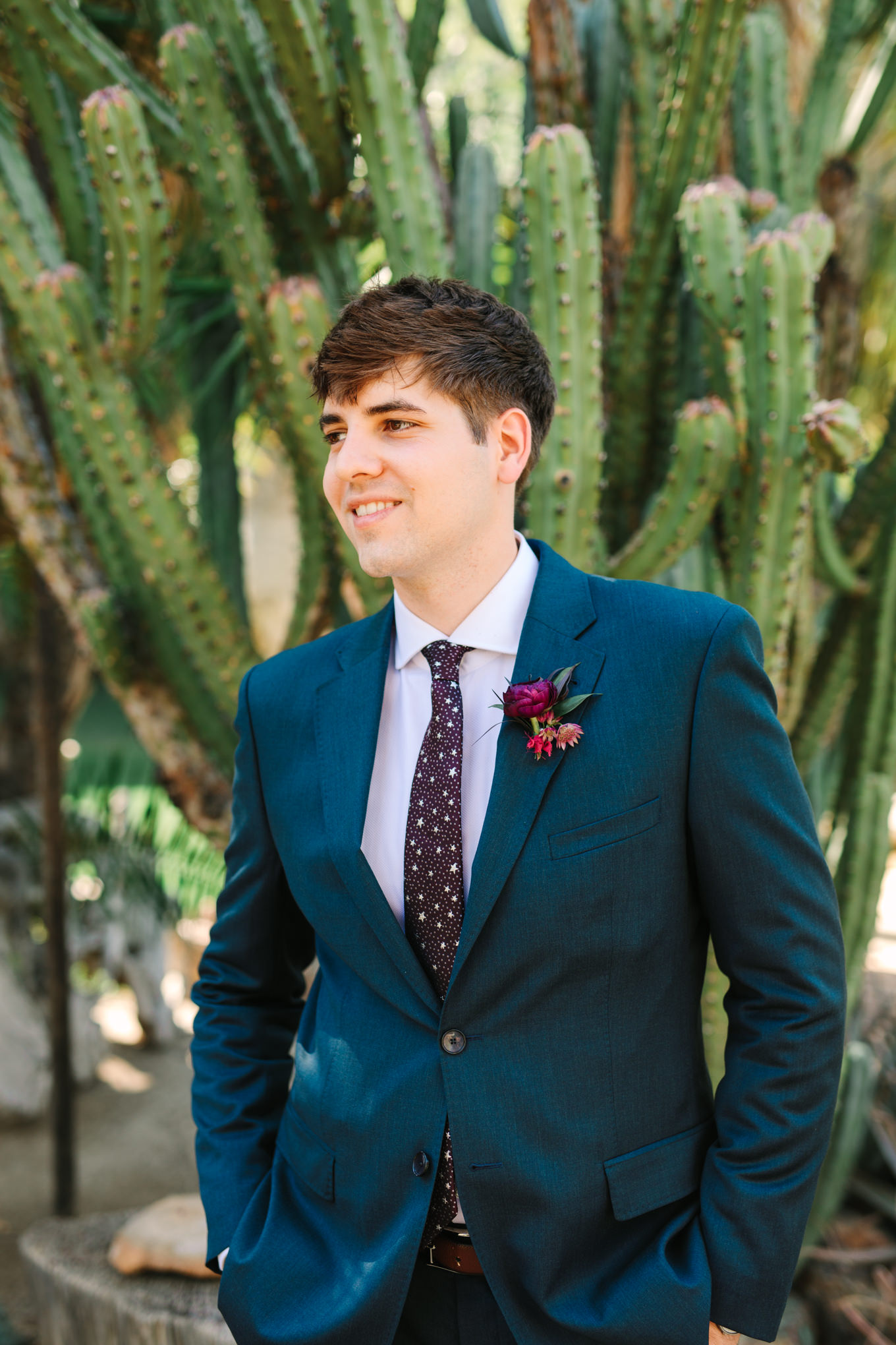 Groom in jewel tone emerald suit with celestial burgundy tie | Colorful jewel tone Palm Springs elopement | Fresh and colorful photography for fun-loving couples in Southern California | #colorfulelopement #palmspringselopement #elopementphotography #palmspringswedding Source: Mary Costa Photography | Los Angeles