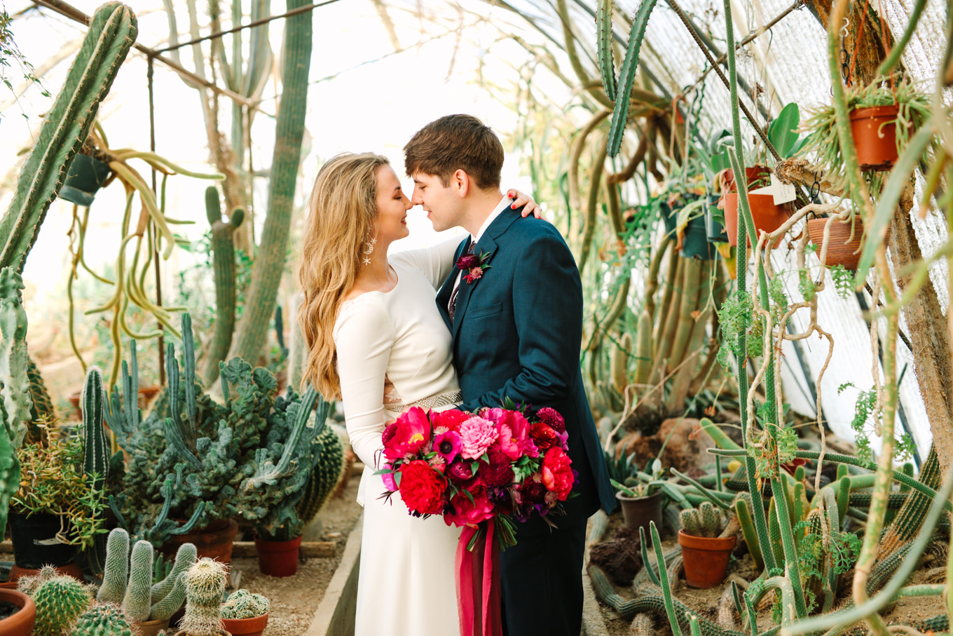 Bride and groom in cactus garden at Moorten Botanical Garden | Colorful jewel tone Palm Springs elopement | Fresh and colorful photography for fun-loving couples in Southern California | #colorfulelopement #palmspringselopement #elopementphotography #palmspringswedding Source: Mary Costa Photography | Los Angeles