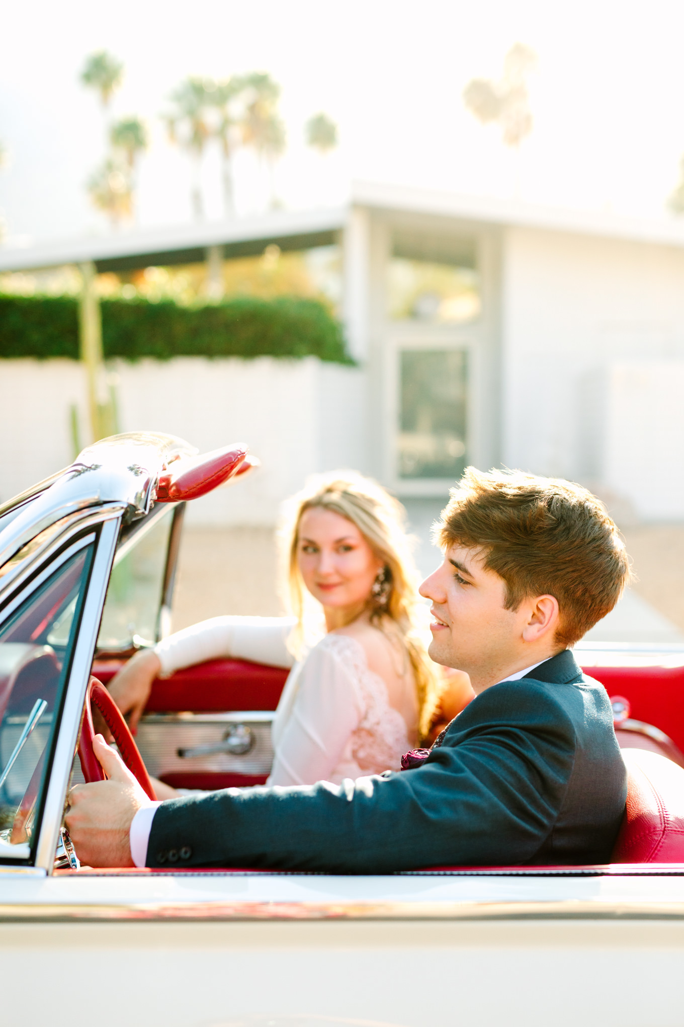 Groom driving classic Ford Thunderbird | Colorful jewel tone Palm Springs elopement | Fresh and colorful photography for fun-loving couples in Southern California | #colorfulelopement #palmspringselopement #elopementphotography #palmspringswedding Source: Mary Costa Photography | Los Angeles