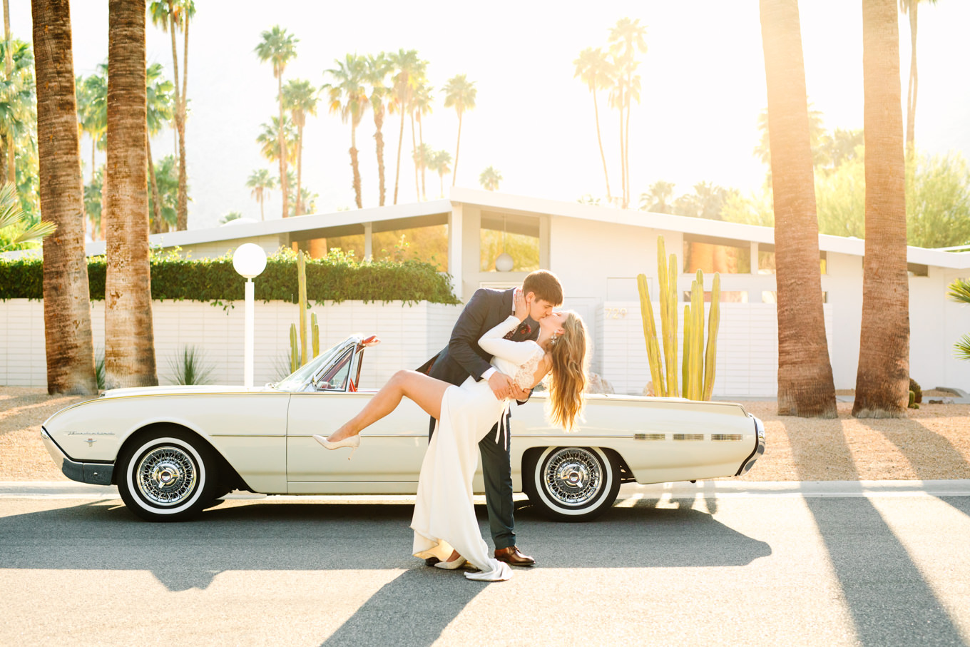 Bride and groom kissing with Ford Thunderbird | Colorful jewel tone Palm Springs elopement | Fresh and colorful photography for fun-loving couples in Southern California | #colorfulelopement #palmspringselopement #elopementphotography #palmspringswedding Source: Mary Costa Photography | Los Angeles