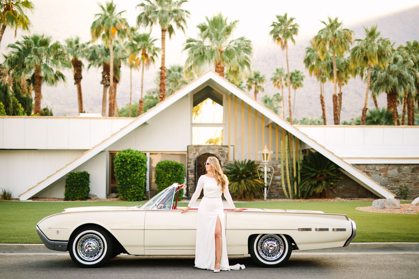 Bride posing with classic Ford Thunderbird car | Colorful jewel tone Palm Springs elopement | Fresh and colorful photography for fun-loving couples in Southern California | #colorfulelopement #palmspringselopement #elopementphotography #palmspringswedding Source: Mary Costa Photography | Los Angeles