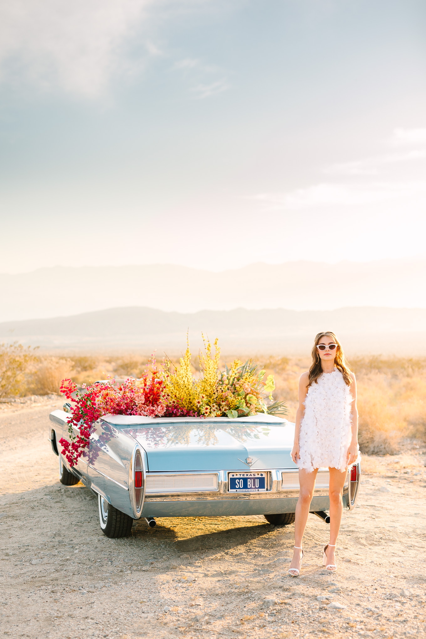 Elopement style with blue classic car filled with flowers | Kindred Presets x Mary Costa Photography Sands Hotel Ad Campaign | Colorful Palm Springs wedding photography | #palmspringsphotographer #lightroompresets #sandshotel #pinkhotel   Source: Mary Costa Photography | Los Angeles