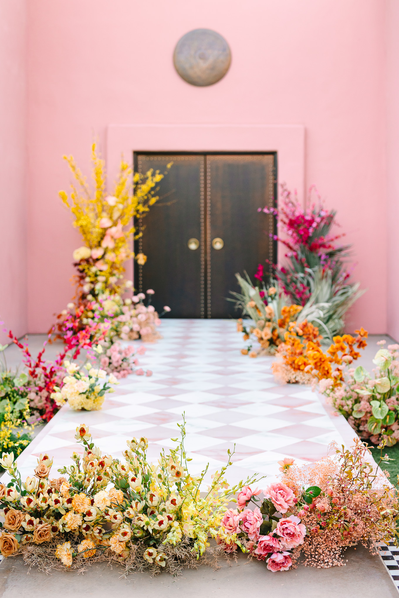 Sands Hotel and Spa Wedding ceremony with pink checker runway and colorful flowers | Kindred Presets x Mary Costa Photography Sands Hotel Ad Campaign | Colorful Palm Springs wedding photography | #palmspringsphotographer #lightroompresets #sandshotel #pinkhotel   Source: Mary Costa Photography | Los Angeles