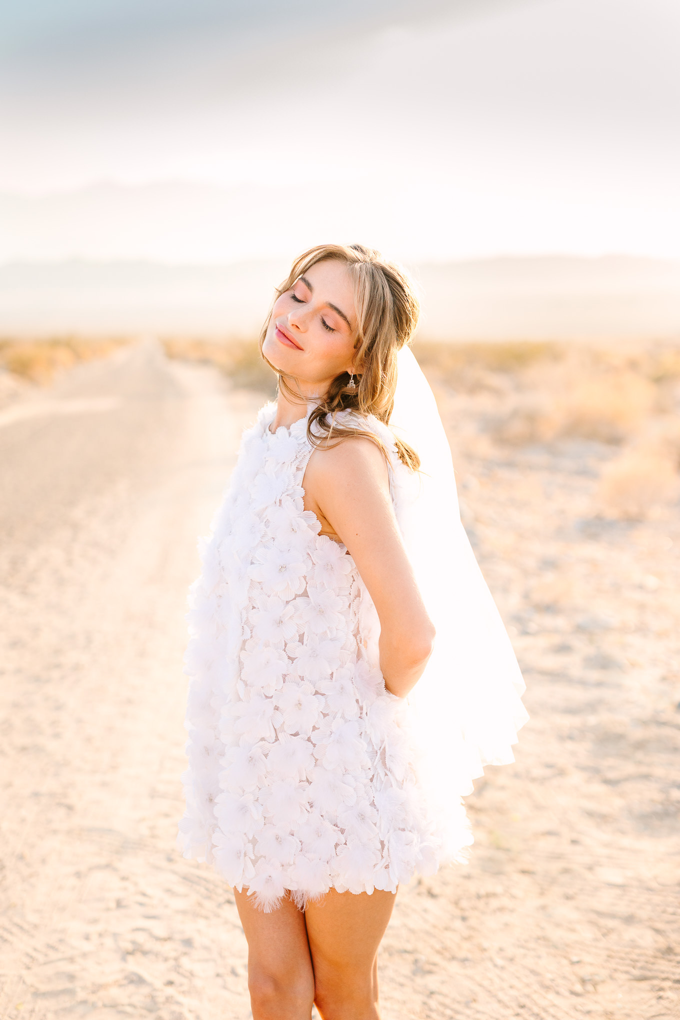 Bridal style with short Naeem Khan feather white dress| Kindred Presets x Mary Costa Photography Palm Springs Ad Campaign | Colorful Palm Springs wedding photography | #palmspringsphotographer #lightroompresets #sandshotel #pinkhotel   Source: Mary Costa Photography | Los Angeles