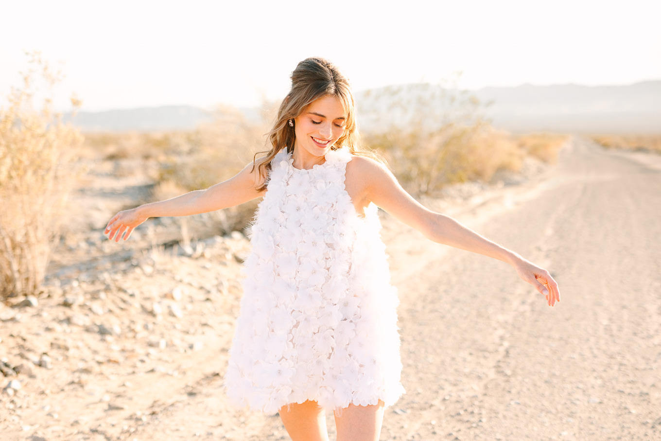 Bridal style with short Naeem Khan feather white dress| Kindred Presets x Mary Costa Photography Palm Springs Ad Campaign | Colorful Palm Springs wedding photography | #palmspringsphotographer #lightroompresets #sandshotel #pinkhotel   Source: Mary Costa Photography | Los Angeles