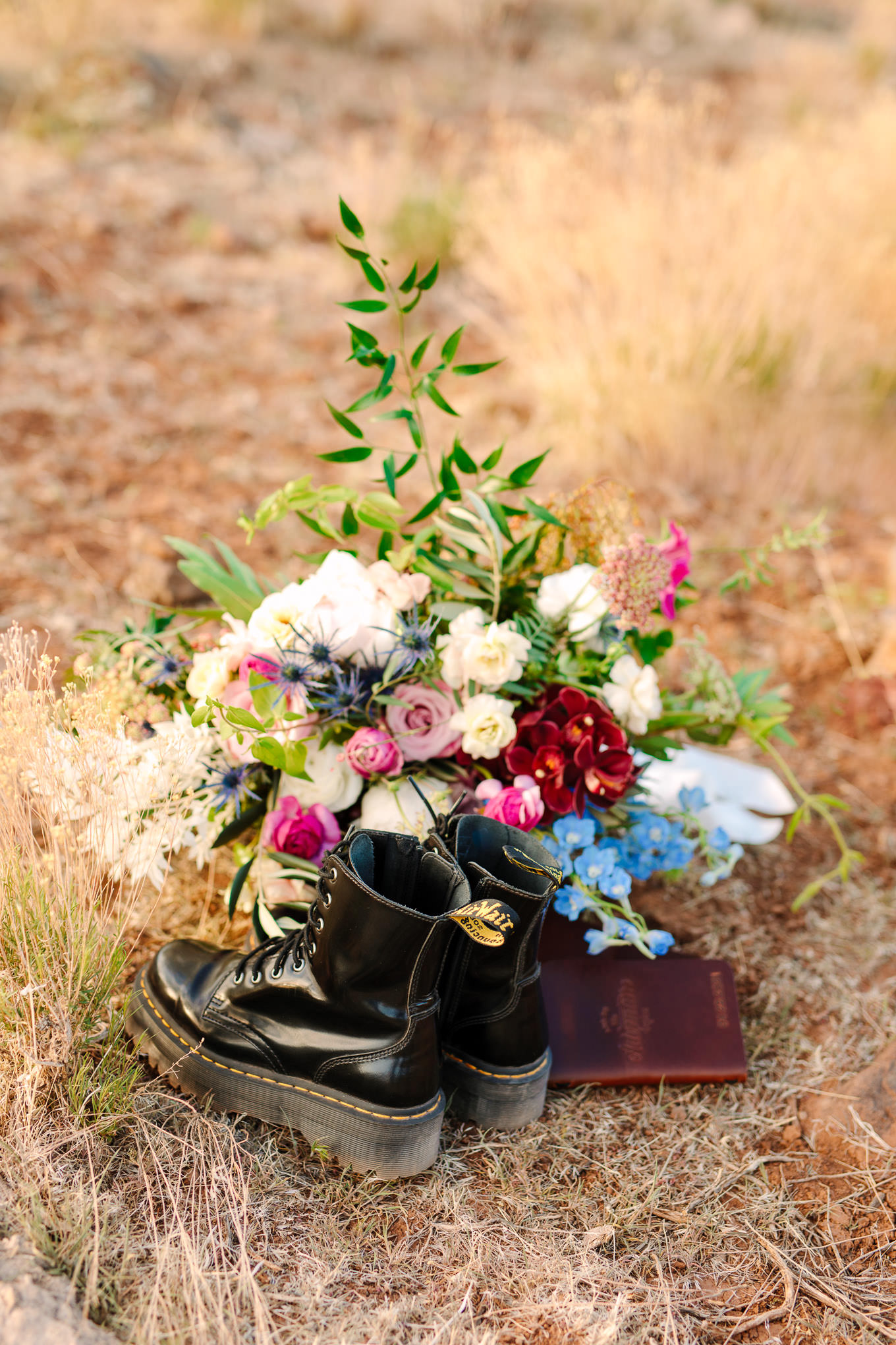 Dr. Martens with vow books and bouquet | Zion Under Canvas Elopement at Sunrise | Colorful adventure elopement photography | #utahelopement #zionelopement #zionwedding #undercanvaszion #sunriseelopement  Source: Mary Costa Photography | Los Angeles