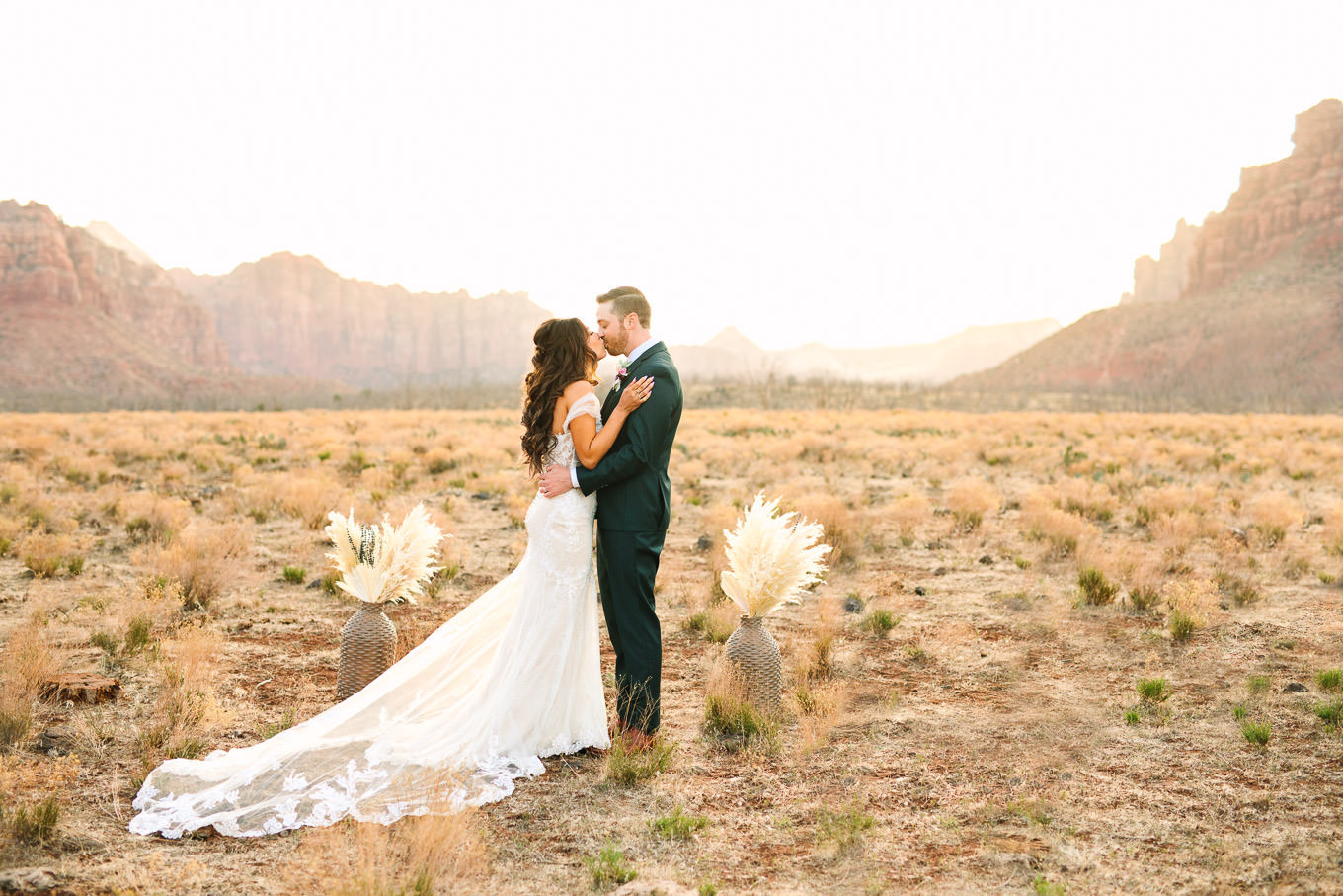 First kiss at private wedding ceremony | Zion Under Canvas camping elopement at sunrise | Colorful elopement photography | #utahelopement #zionelopement #zionwedding #undercanvaszion #sunriseelopement #adventureelopement  Source: Mary Costa Photography | Los Angeles