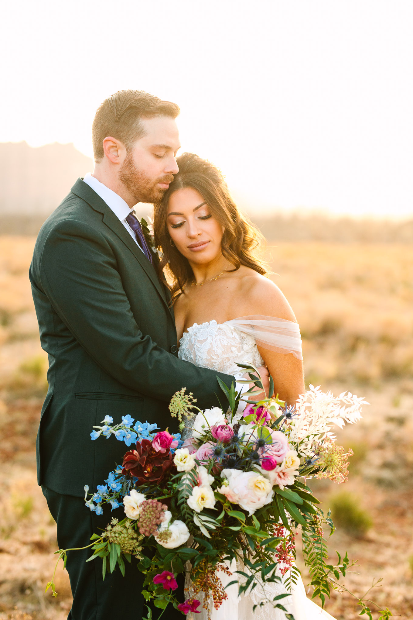 Bride with groom in green suit portraits | Zion Under Canvas camping elopement at sunrise | Colorful elopement photography | #utahelopement #zionelopement #zionwedding #undercanvaszion #sunriseelopement #adventureelopement  Source: Mary Costa Photography | Los Angeles