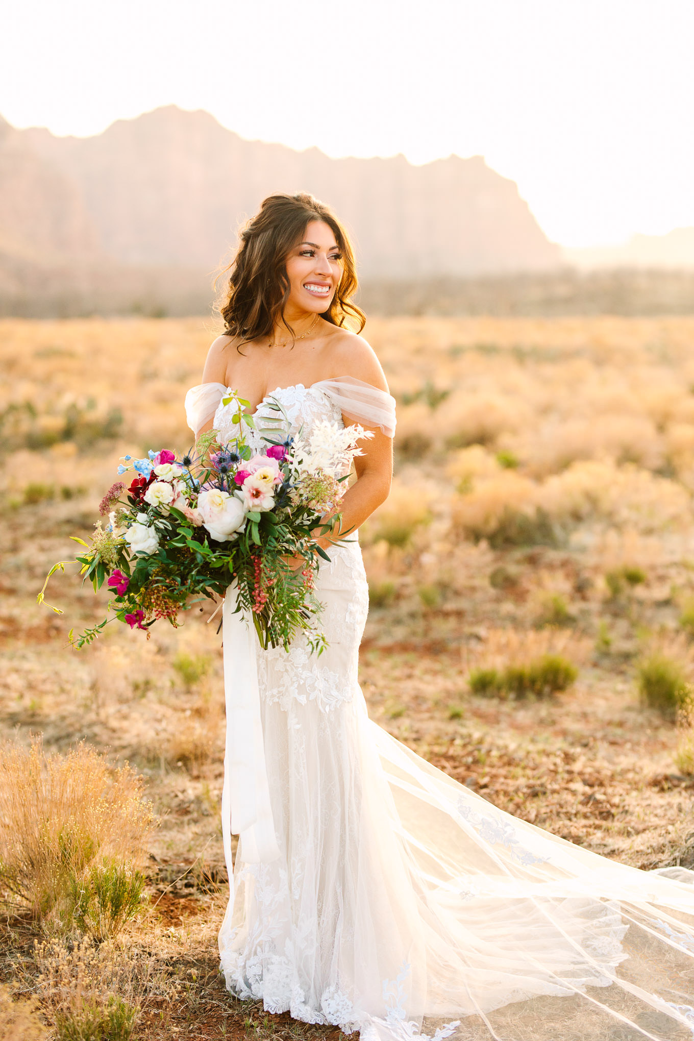Bridal portrait with colorful bouquet | Zion Under Canvas camping elopement at sunrise | Colorful elopement photography | #utahelopement #zionelopement #zionwedding #undercanvaszion #sunriseelopement #adventureelopement  Source: Mary Costa Photography | Los Angeles