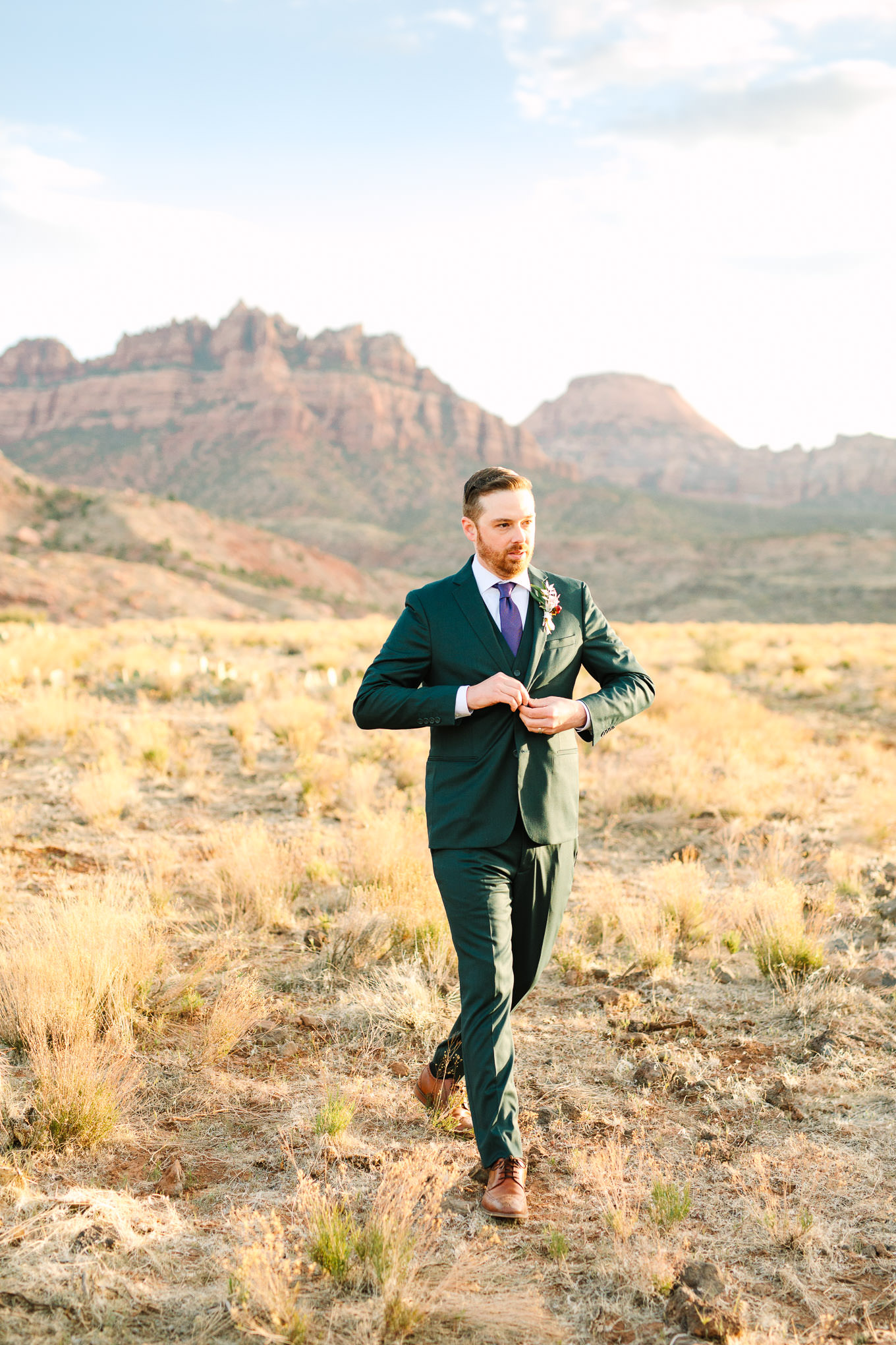 Groom portrait in green suit | Zion Under Canvas camping elopement at sunrise | Colorful elopement photography | #utahelopement #zionelopement #zionwedding #undercanvaszion #sunriseelopement #adventureelopement  Source: Mary Costa Photography | Los Angeles