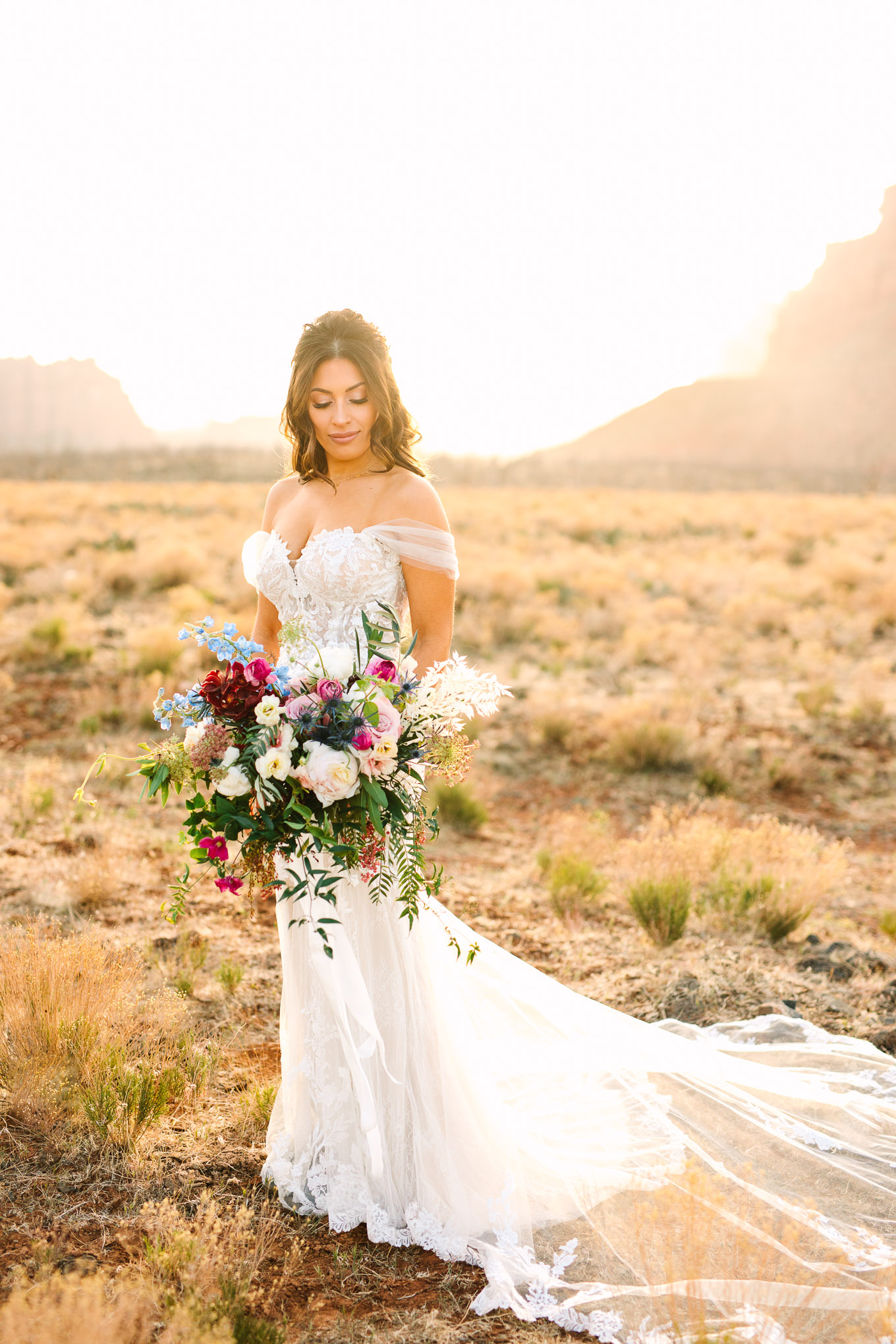 Bridal portrait with colorful bouquet | Zion Under Canvas camping elopement at sunrise | Colorful elopement photography | #utahelopement #zionelopement #zionwedding #undercanvaszion #sunriseelopement #adventureelopement  Source: Mary Costa Photography | Los Angeles