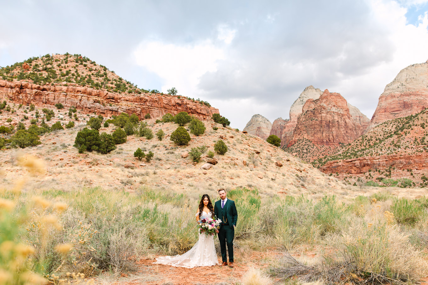 Groom in green suit with bride in Zion National Park | Zion National Park elopement | Colorful adventure elopement photography | #utahelopement #zionelopement #zionwedding #undercanvaszion   Source: Mary Costa Photography | Los Angeles