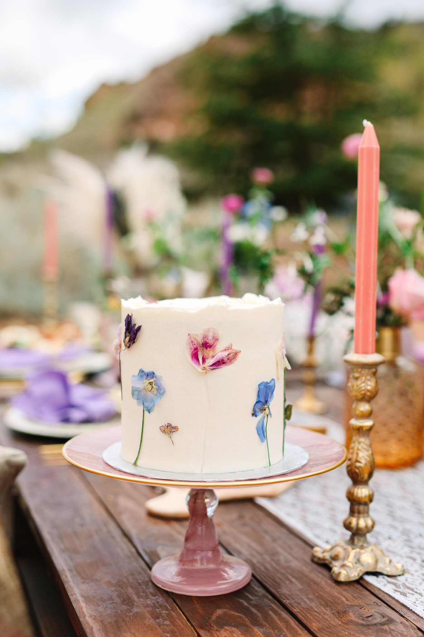 Pressed flower cake at Purple and jewel tone picnic setup | Zion National Park elopement | Colorful adventure elopement photography | #utahelopement #zionelopement #zionwedding #undercanvaszion #picnicwedding  Source: Mary Costa Photography | Los Angeles
