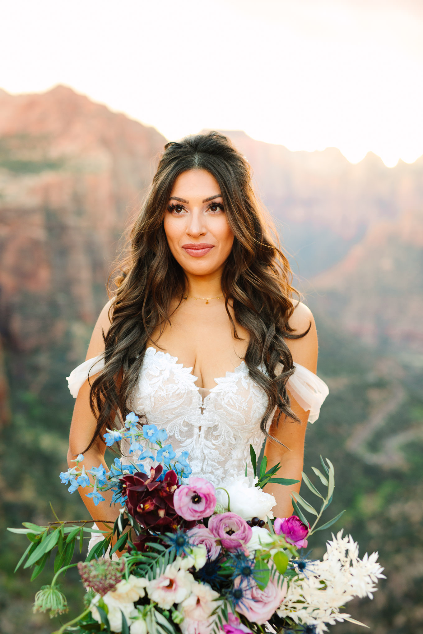 Gorgeous bride in off the shoulder gown | Zion National Park sunset elopement scenic overlook | Colorful adventure elopement photography | #utahelopement #zionelopement #zionwedding #undercanvaszion   Source: Mary Costa Photography | Los Angeles