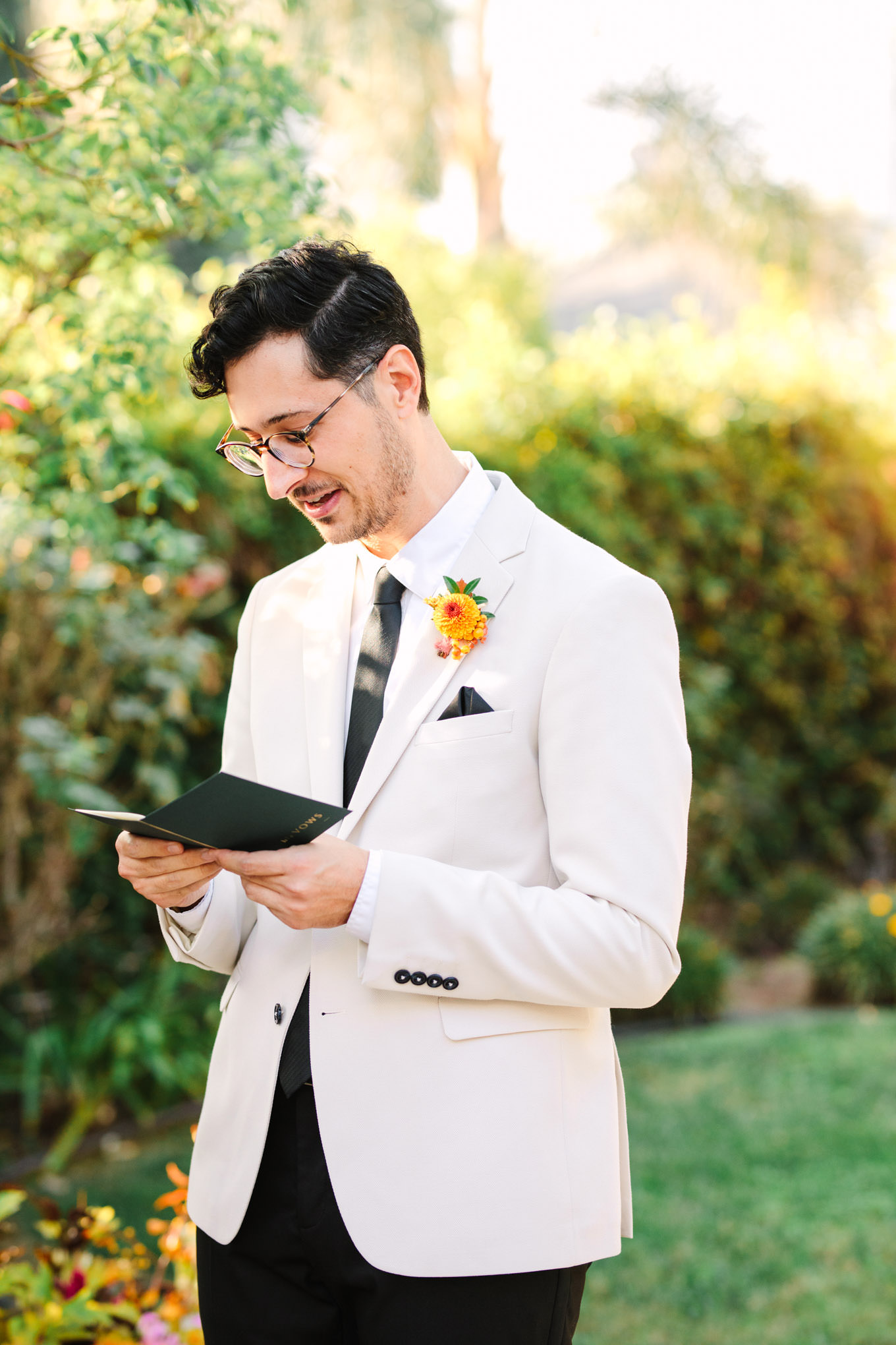 Groom portrait reading his vows | Vibrant backyard micro wedding featured on Green Wedding Shoes | Colorful LA wedding photography | #losangeleswedding #backyardwedding #microwedding #laweddingphotographer Source: Mary Costa Photography | Los Angeles