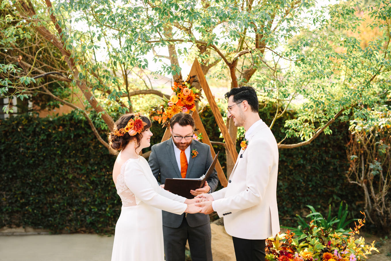 Bride and groom in front of unique backdrop | Vibrant backyard micro wedding featured on Green Wedding Shoes | Colorful LA wedding photography | #losangeleswedding #backyardwedding #microwedding #laweddingphotographer Source: Mary Costa Photography | Los Angeles