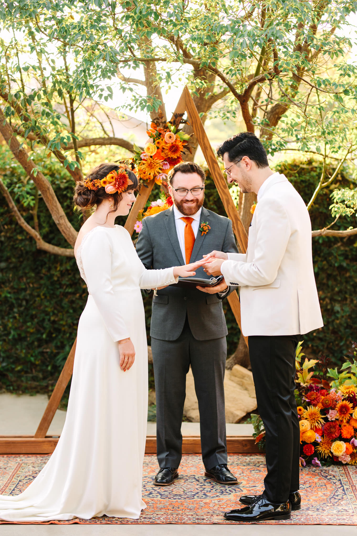 Bride and groom exchanging rings | Vibrant backyard micro wedding featured on Green Wedding Shoes | Colorful LA wedding photography | #losangeleswedding #backyardwedding #microwedding #laweddingphotographer Source: Mary Costa Photography | Los Angeles
