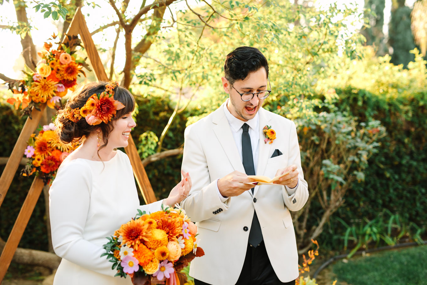 Groom reading a personal note to the bride | Vibrant backyard micro wedding featured on Green Wedding Shoes | Colorful LA wedding photography | #losangeleswedding #backyardwedding #microwedding #laweddingphotographer Source: Mary Costa Photography | Los Angeles