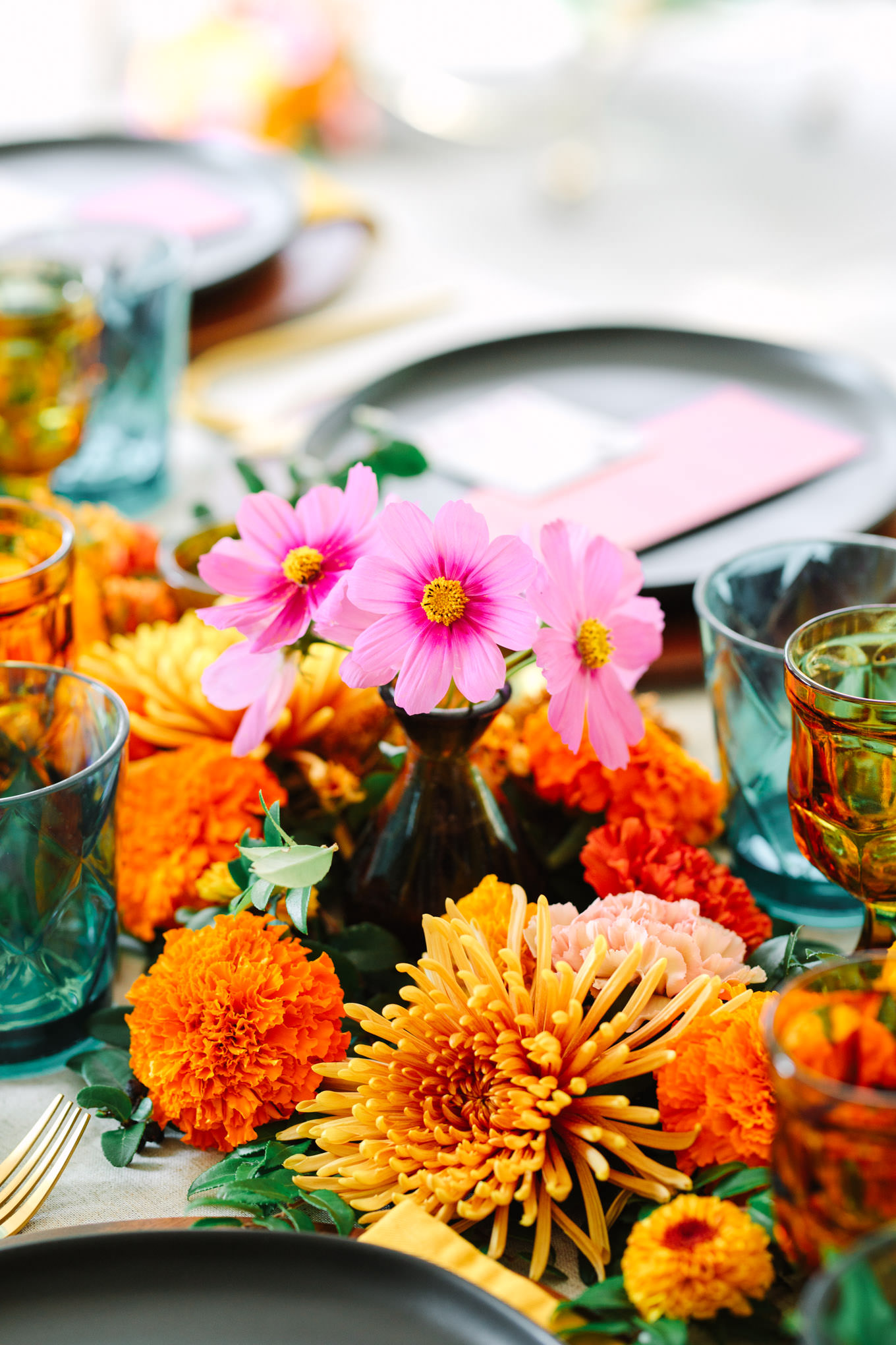 Stunning bold and bright floral arrangements on table for wedding reception | Vibrant backyard micro wedding featured on Green Wedding Shoes | Colorful LA wedding photography | #losangeleswedding #backyardwedding #microwedding #laweddingphotographer Source: Mary Costa Photography | Los Angeles