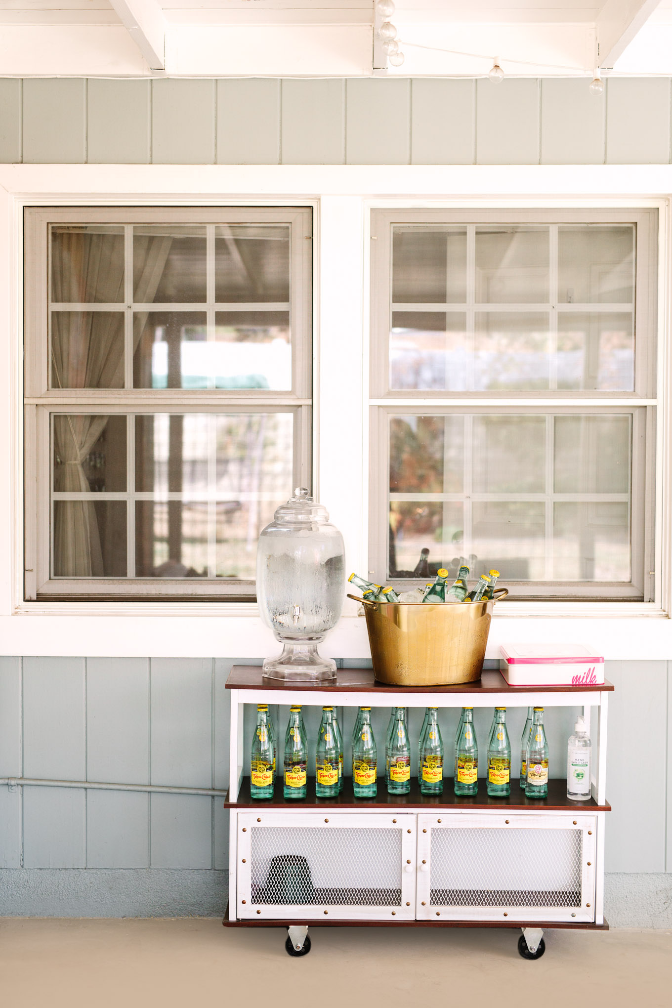 Unique water station for California micro wedding | Vibrant backyard micro wedding featured on Green Wedding Shoes | Colorful LA wedding photography | #losangeleswedding #backyardwedding #microwedding #laweddingphotographer Source: Mary Costa Photography | Los Angeles
