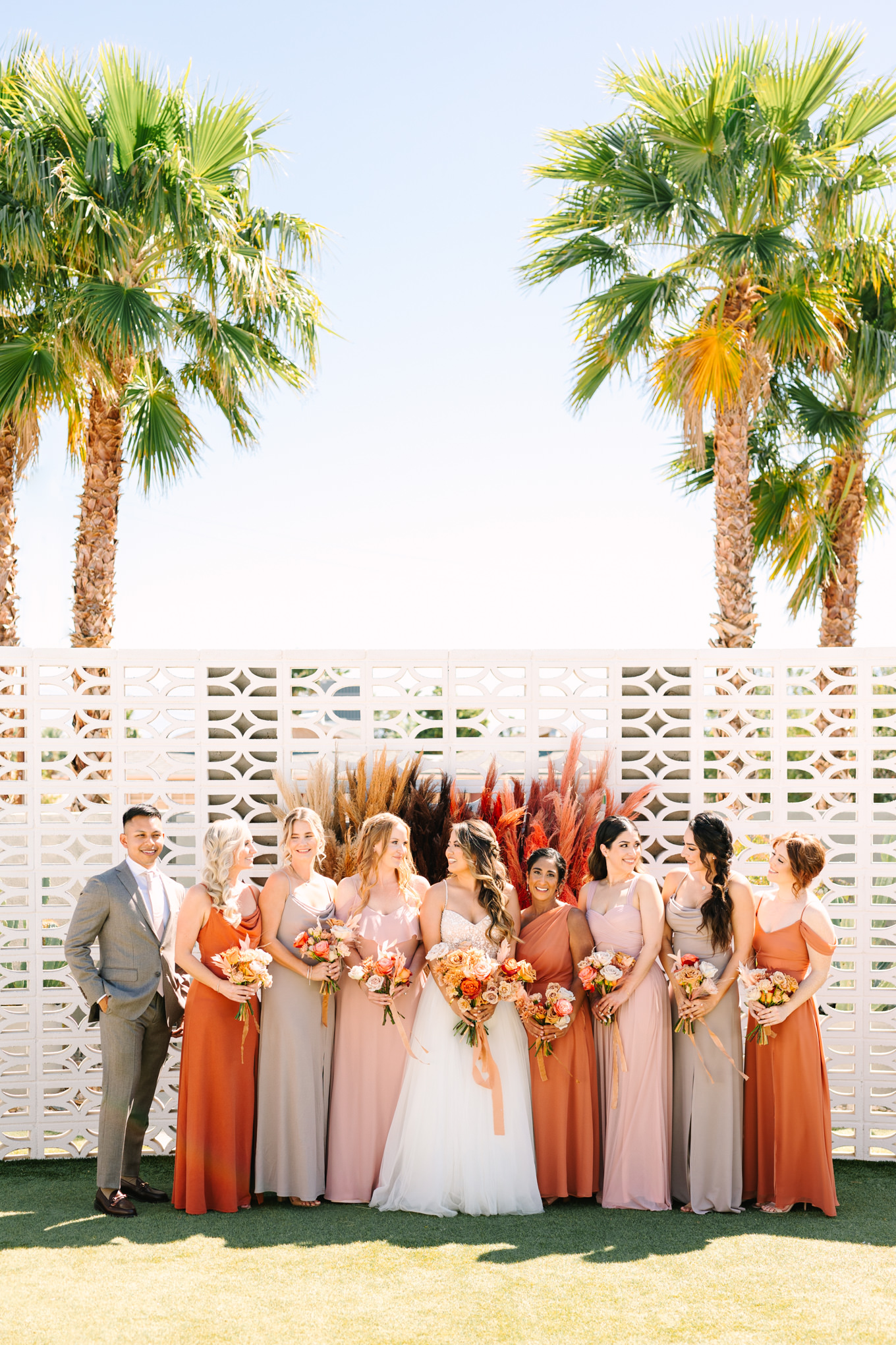 Bridal party in terra cotta, pink, and gray | Pink and orange Lautner Compound wedding | Colorful Palm Springs wedding photography | #palmspringsphotographer #palmspringswedding #lautnercompound #southerncaliforniawedding  Source: Mary Costa Photography | Los Angeles