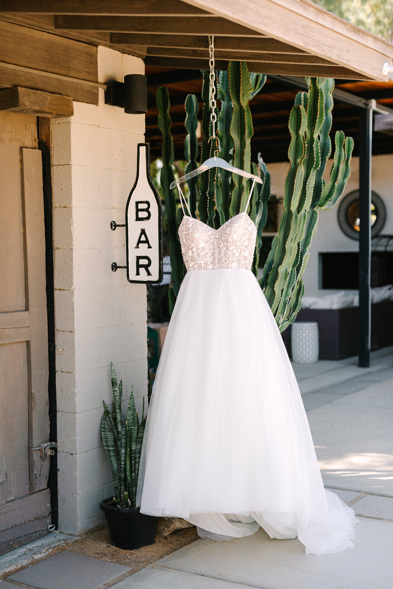 Bridal gown hanging | Pink and orange Lautner Compound wedding | Colorful Palm Springs wedding photography | #palmspringsphotographer #palmspringswedding #lautnercompound #southerncaliforniawedding  Source: Mary Costa Photography | Los Angeles
