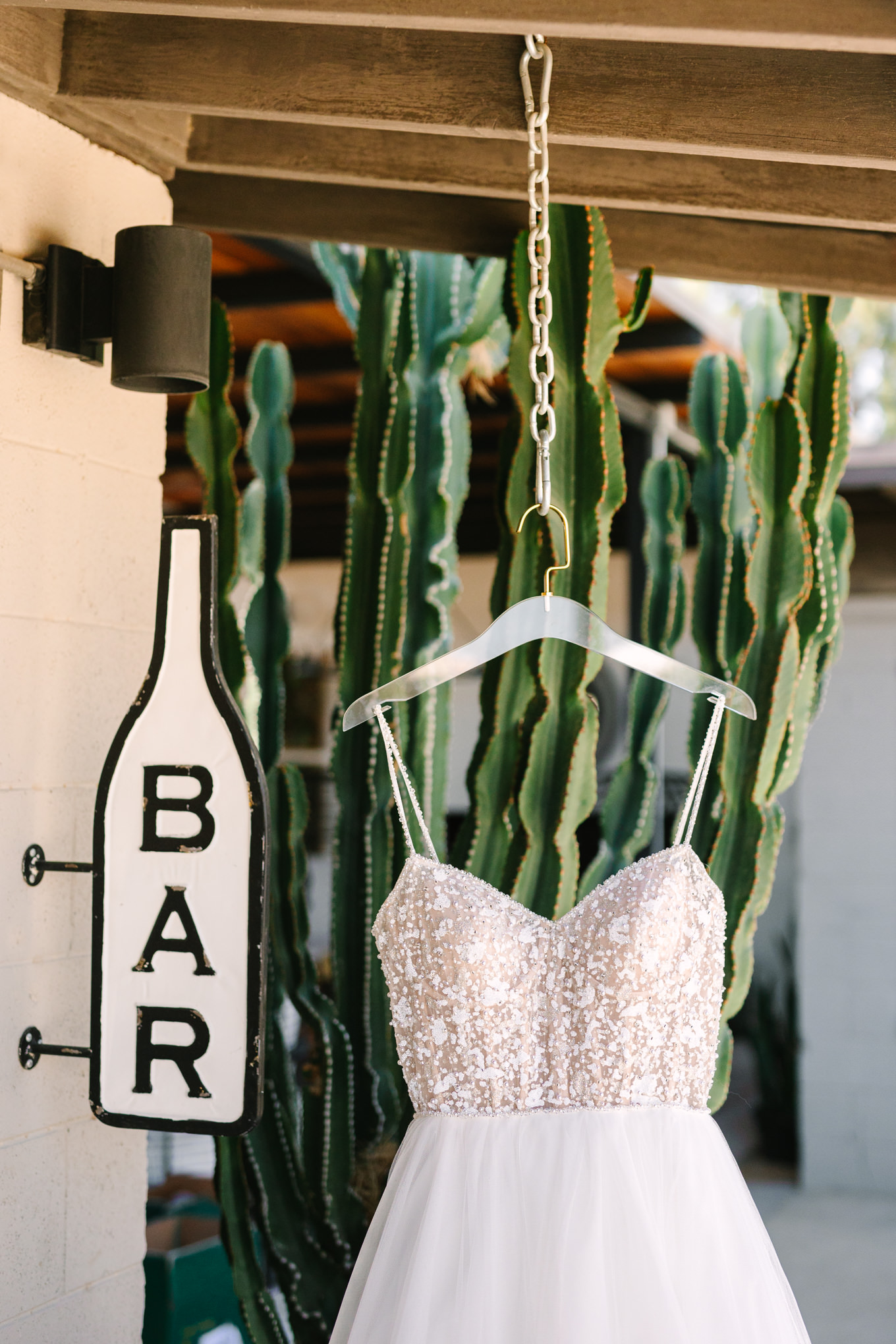 Bridal gown hanging at The Lautner Compound | Pink and orange Lautner Compound wedding | Colorful Palm Springs wedding photography | #palmspringsphotographer #palmspringswedding #lautnercompound #southerncaliforniawedding  Source: Mary Costa Photography | Los Angeles