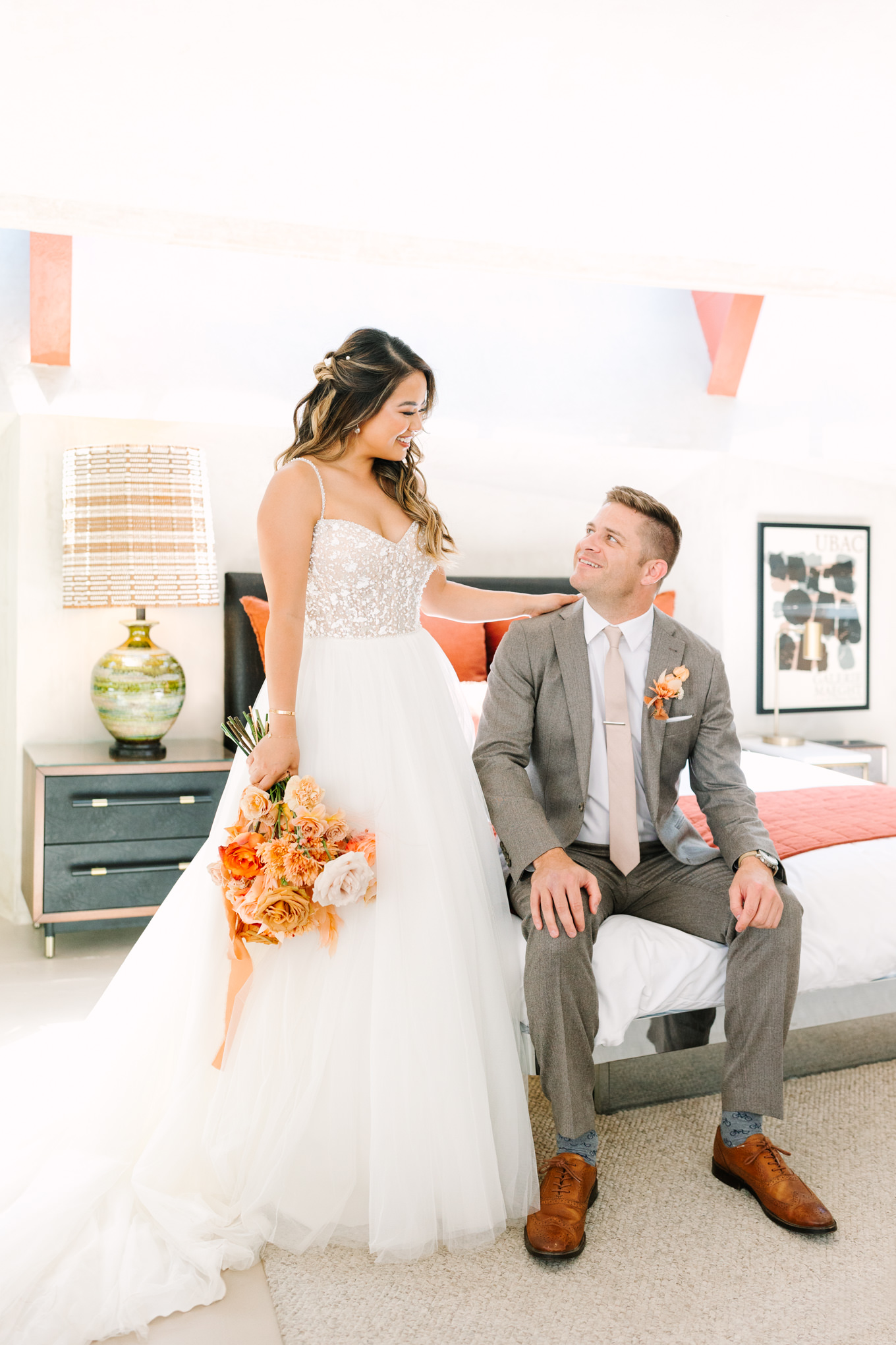 Bride and groom in mid century modern room | Pink and orange Lautner Compound wedding | Colorful Palm Springs wedding photography | #palmspringsphotographer #palmspringswedding #lautnercompound #southerncaliforniawedding  Source: Mary Costa Photography | Los Angeles