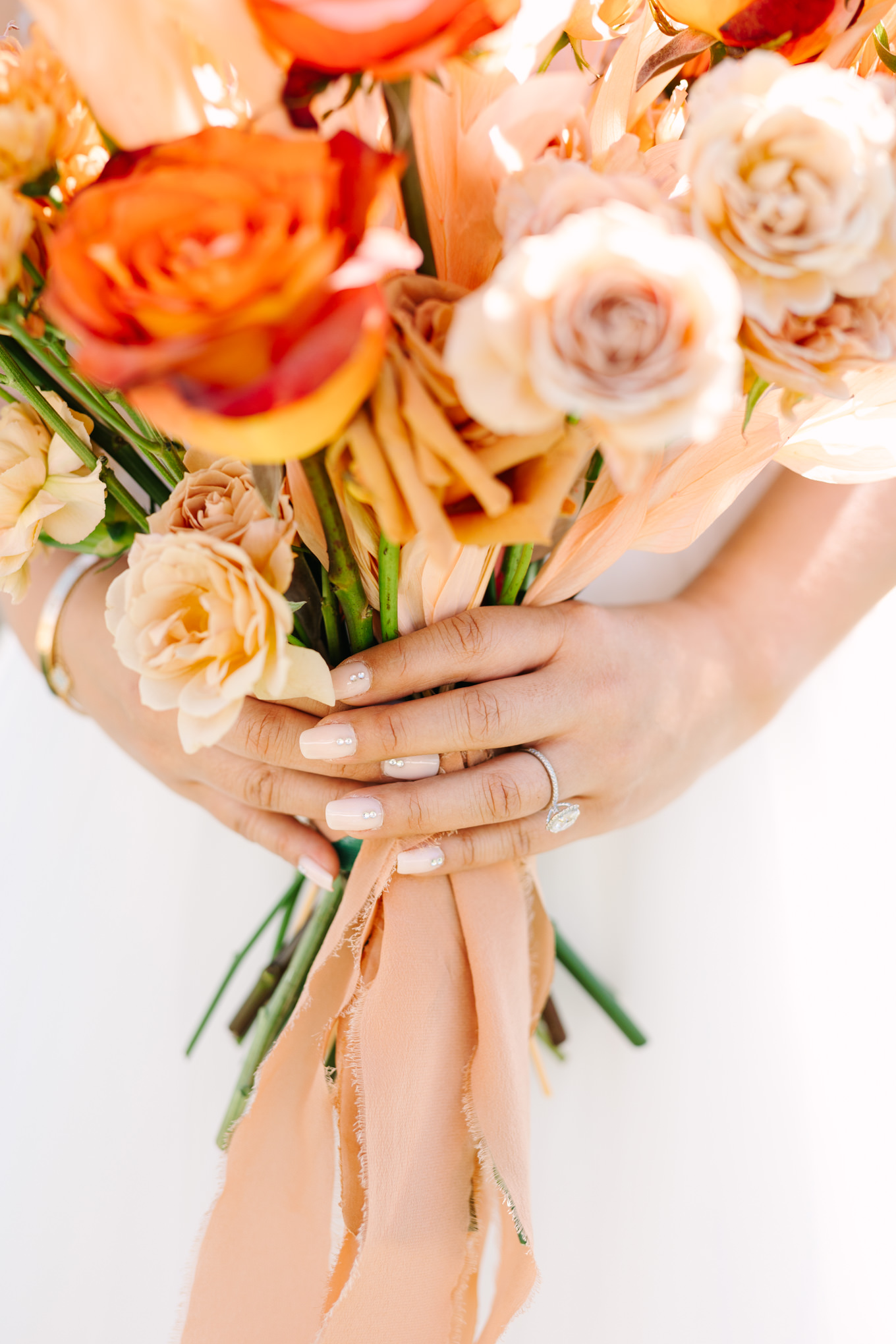Wedding ring close up on bouquet | Pink and orange Lautner Compound wedding | Colorful Palm Springs wedding photography | #palmspringsphotographer #palmspringswedding #lautnercompound #southerncaliforniawedding  Source: Mary Costa Photography | Los Angeles